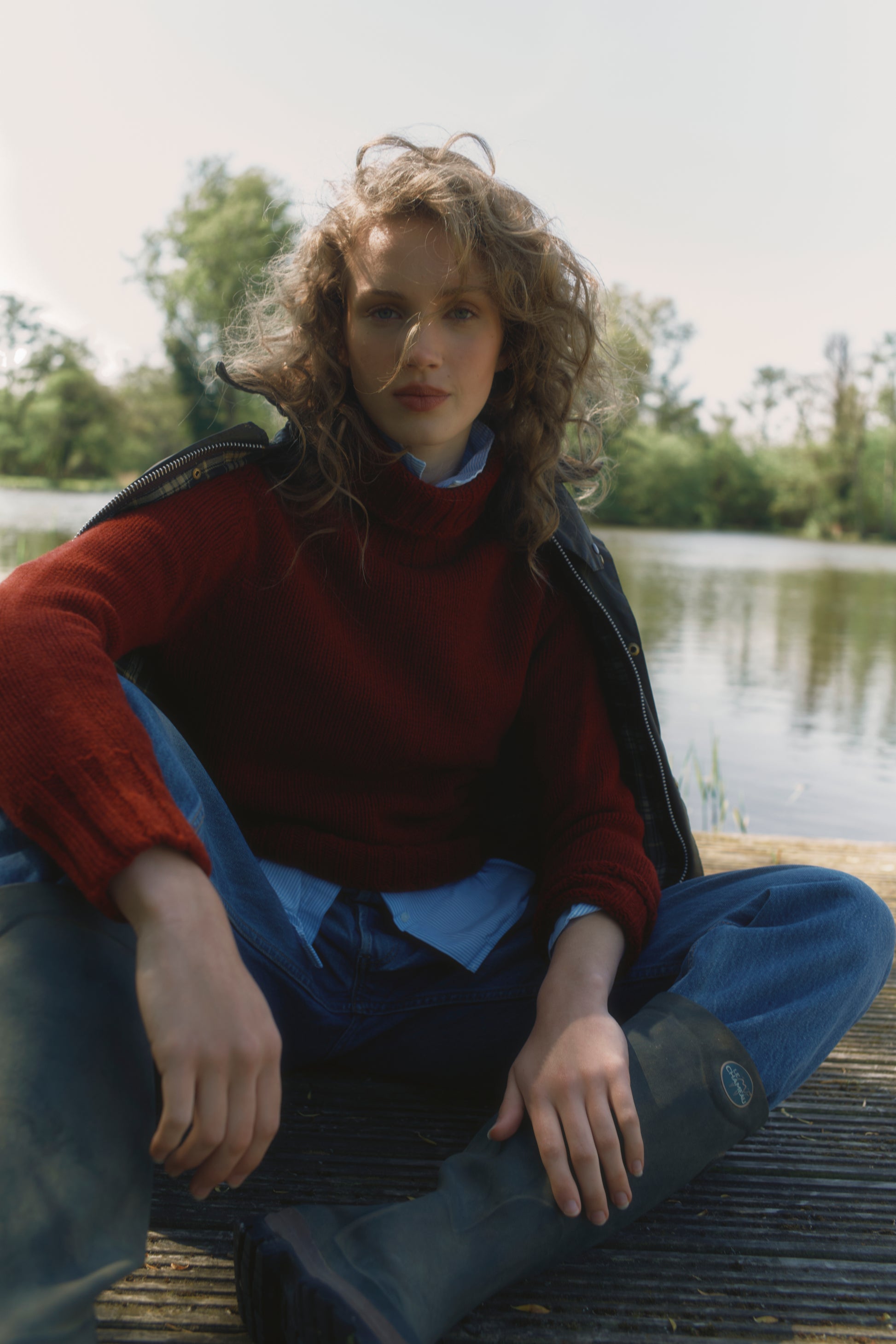 Model wearing a Big Softy Geelong Chunky Polo Neck Womens Jumper in colour Russet Red.