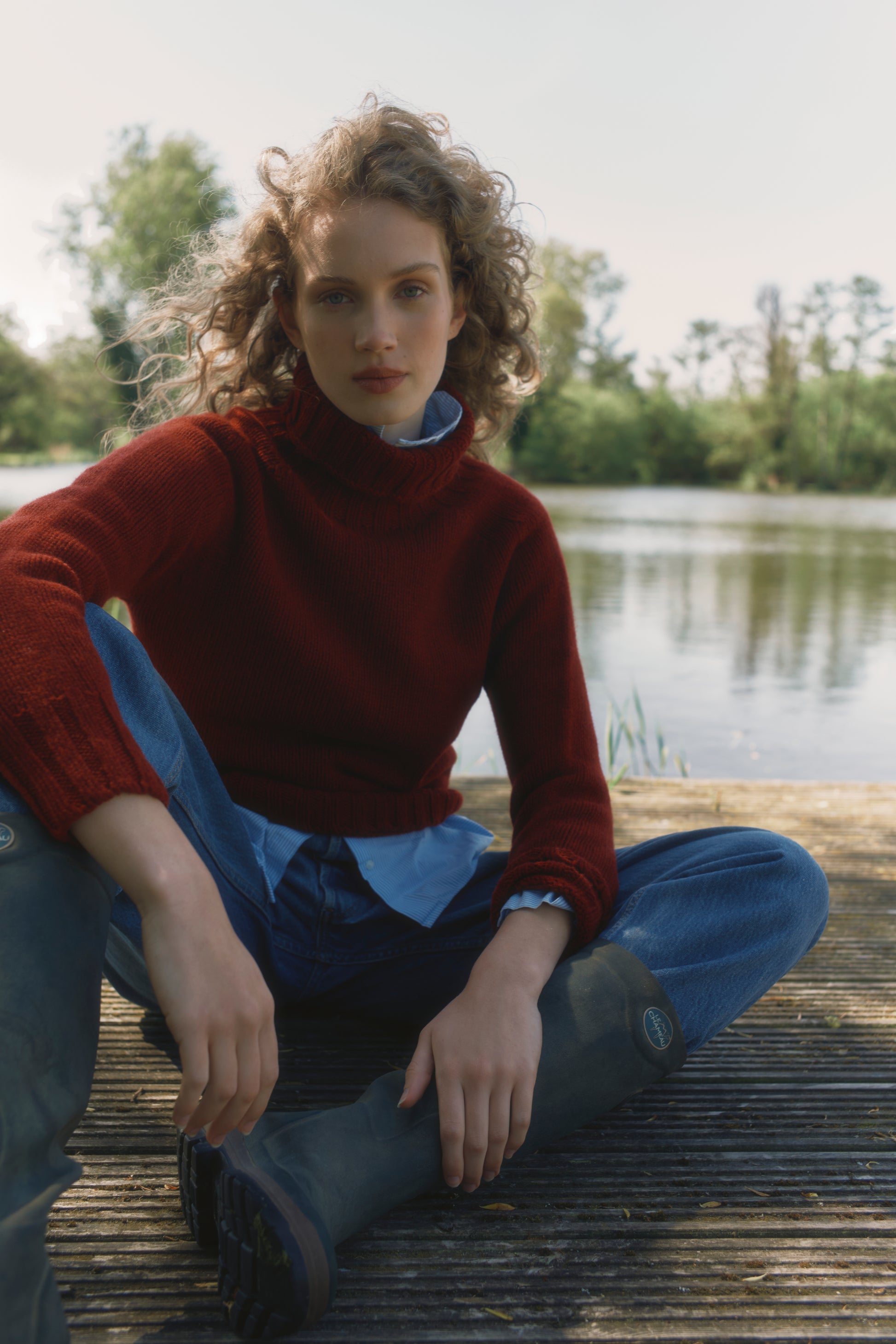 Model wearing a Big Softy Geelong Chunky Polo Neck Womens Jumper in colour Russet Red.