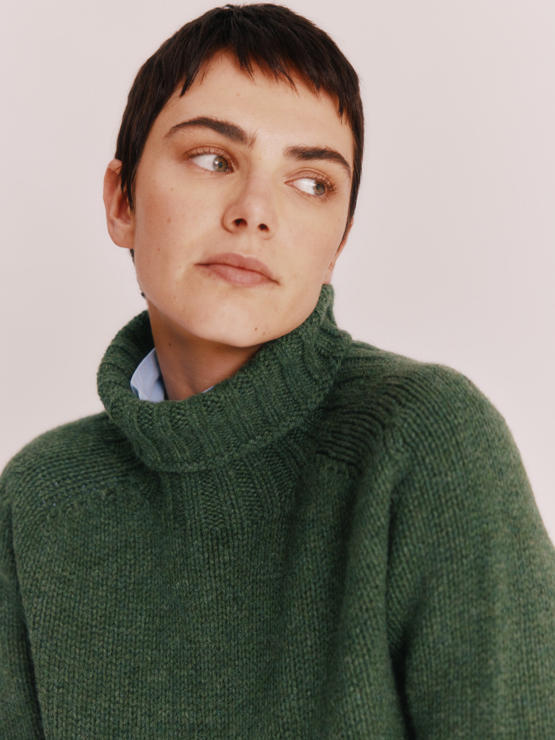 Model wearing a Bosie Knitwear Big Softy Geelong Chunky Polo Neck Womens Jumper in colour Serpentine Green.