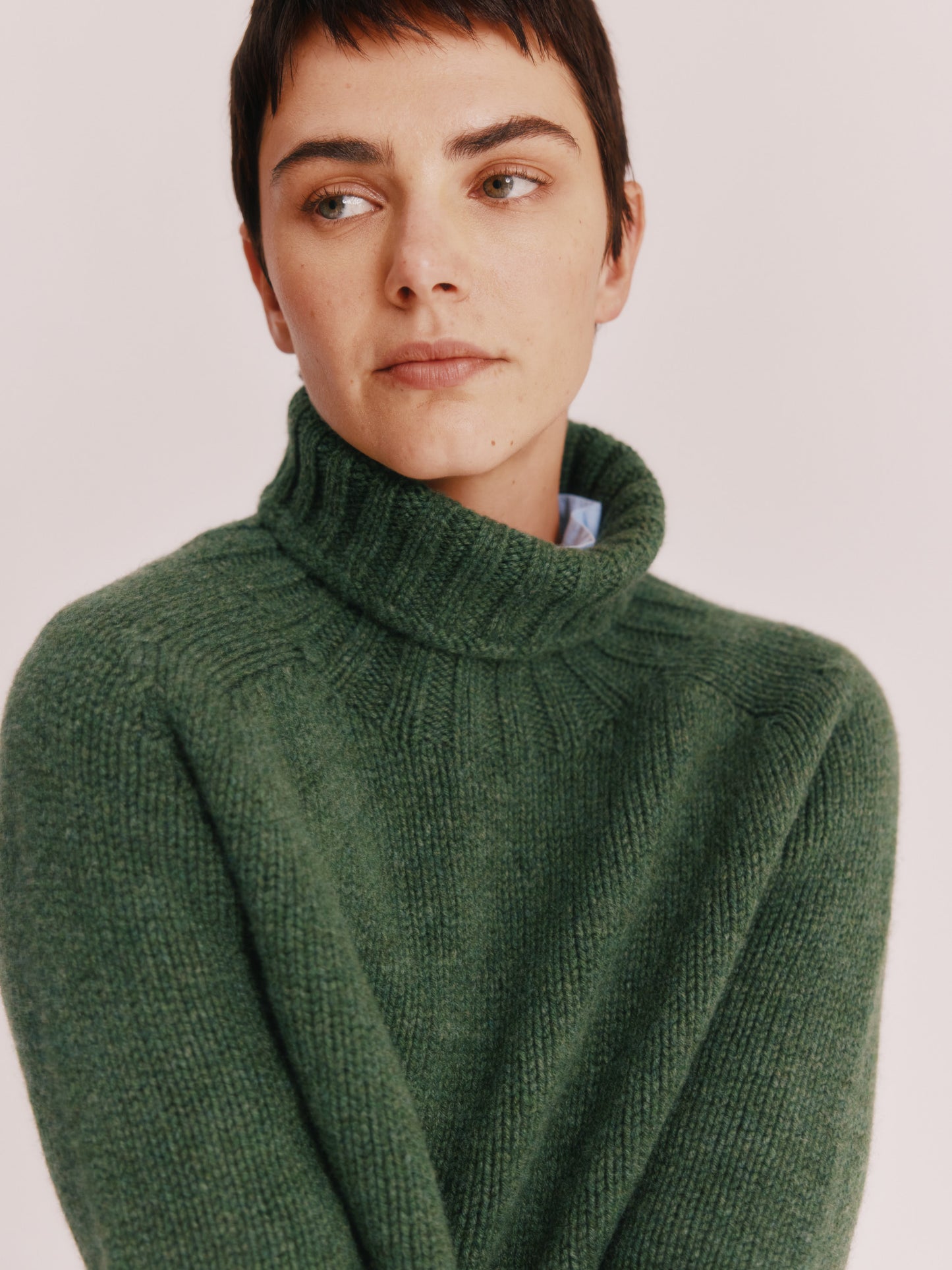 Model wearing a Bosie Knitwear Big Softy Geelong Chunky Polo Neck Womens Jumper in colour Serpentine Green.