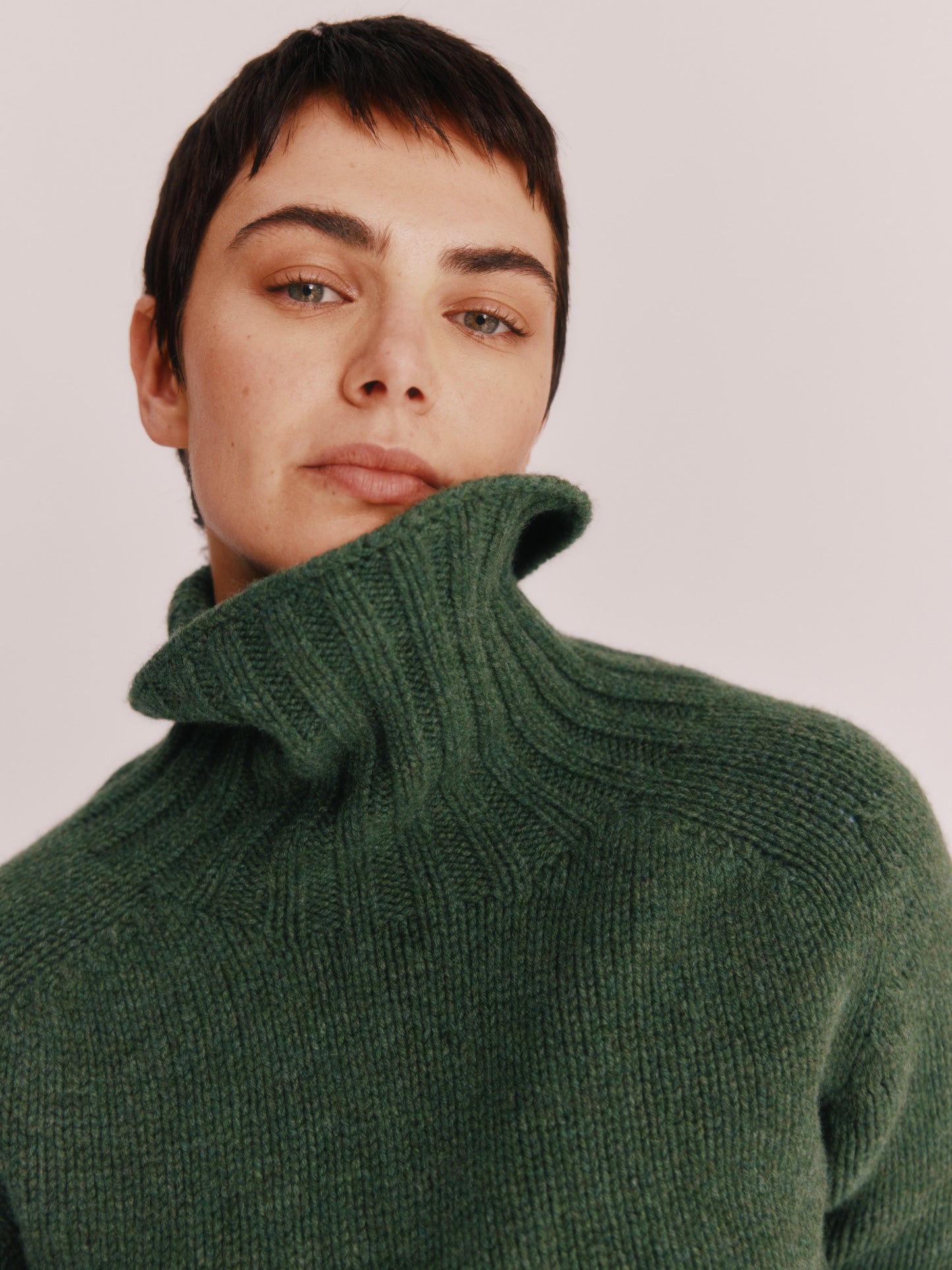 Model wearing a Bosie Knitwear Big Softy Geelong Chunky Polo Neck Womens Jumper in colour Serpentine Green.