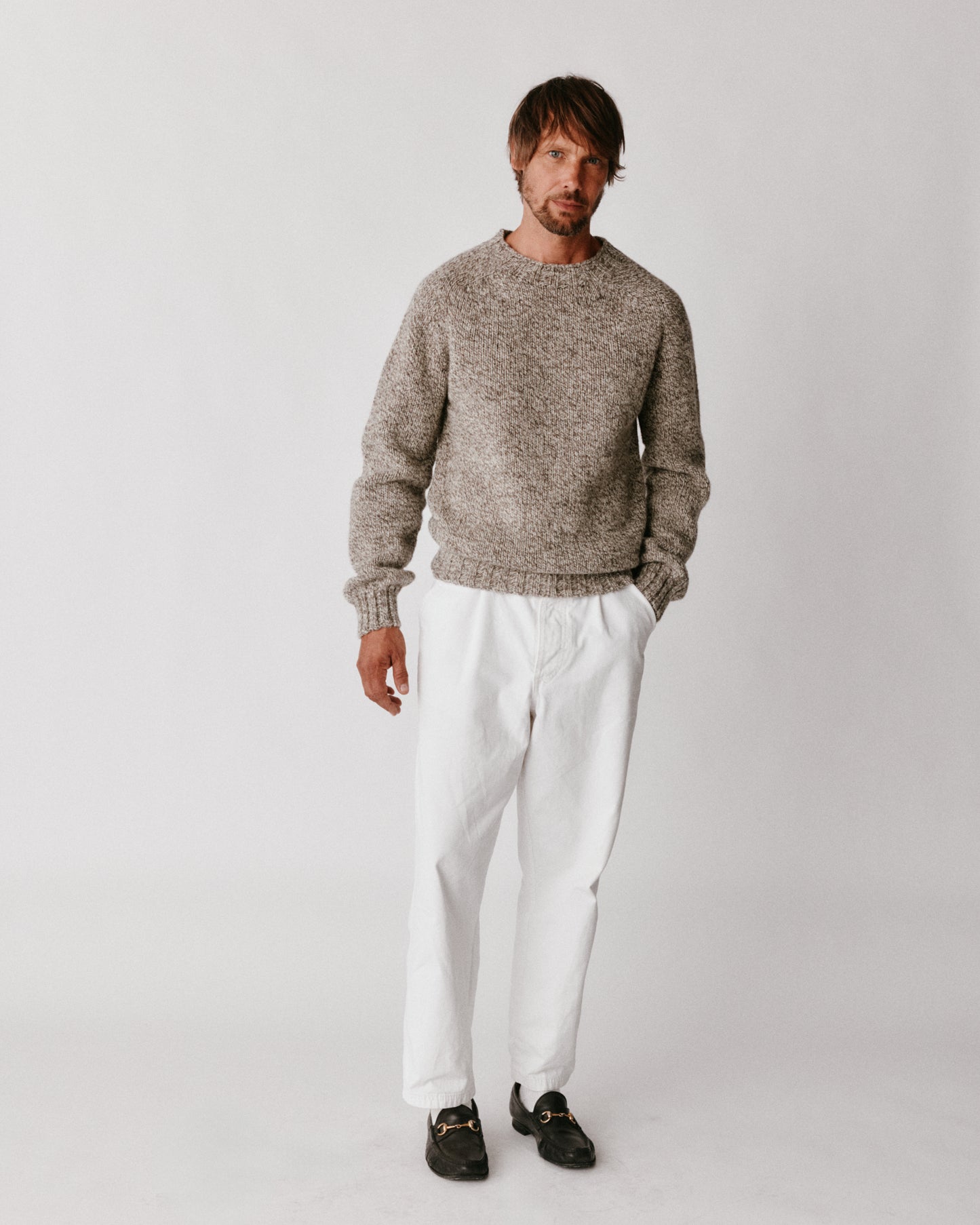 A model wearing a Bosie Blue Mogganer British Breed Sweater in colour Herdwick.