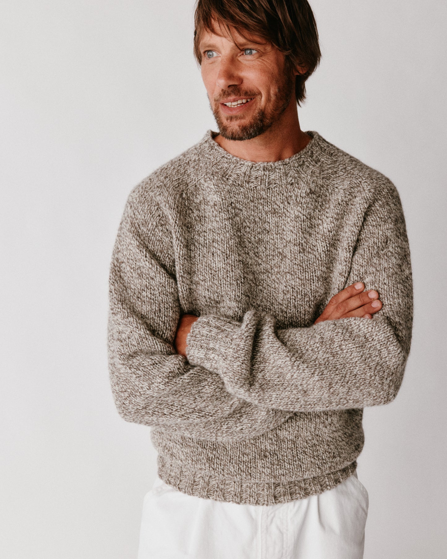 A model wearing a Blue Mogganer British Breed Sweater in colour Herdwick.