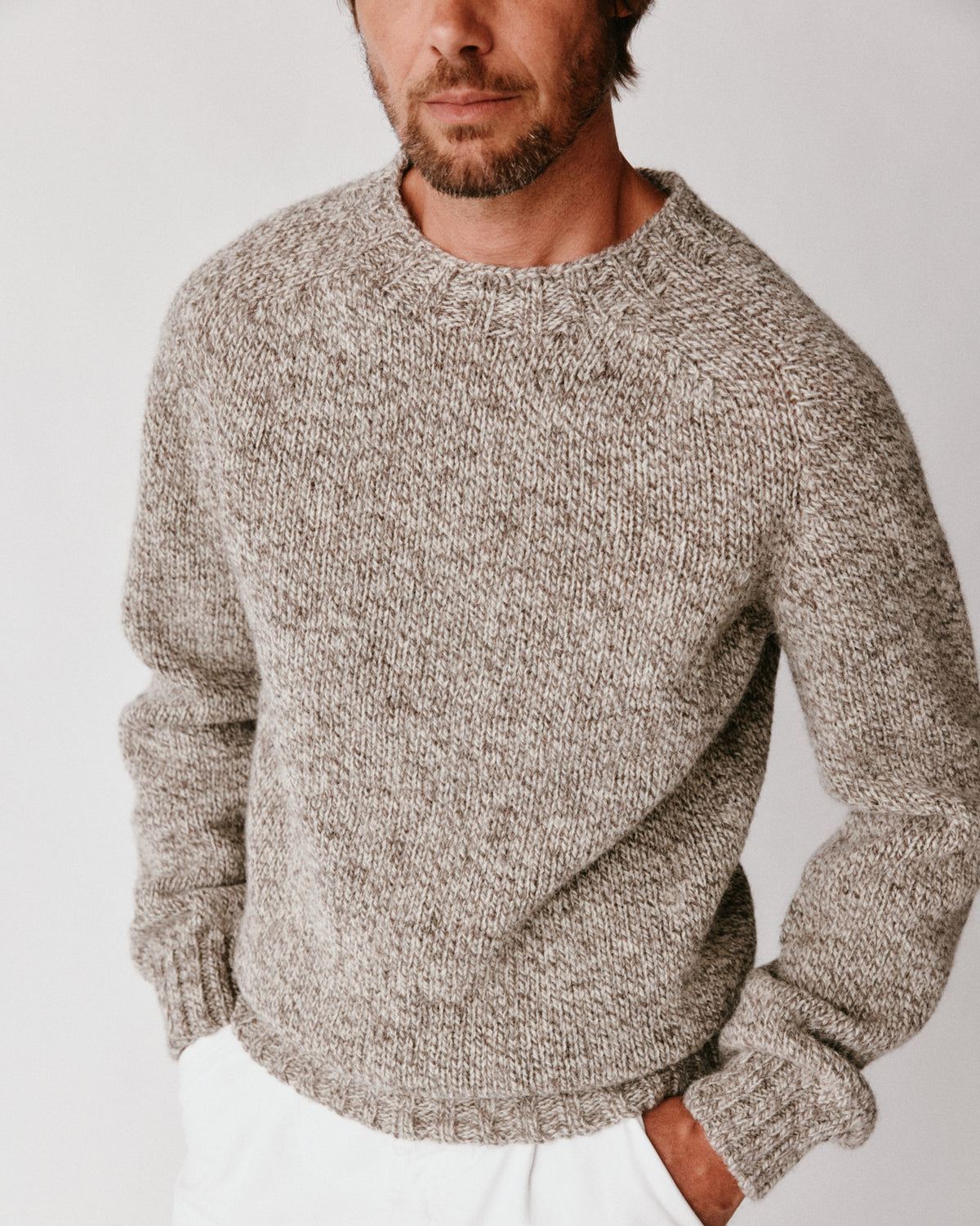 A model wearing a Bosie Blue Mogganer British Breed Sweater in colour Herdwick.