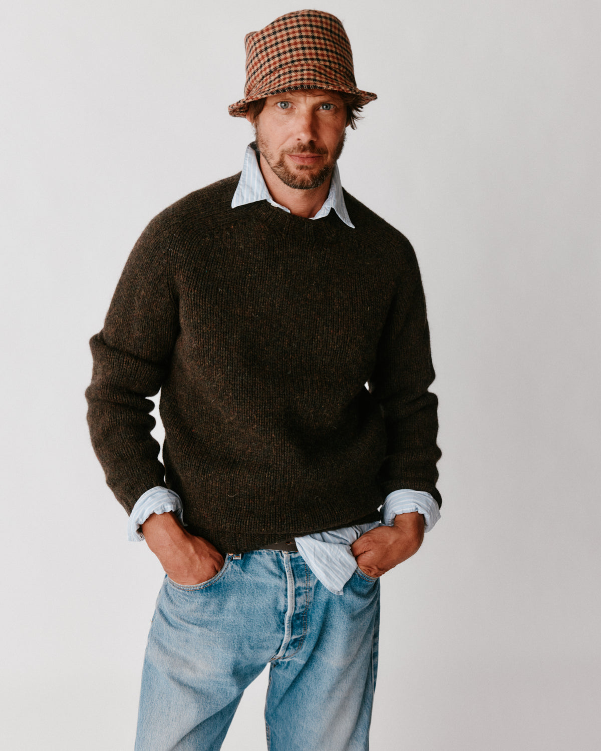 A model wearing a Bosie Blue Mogganer Explorer Extra Chunky Seamless Supersoft Shetland Sweater in colour Carob / Turin.