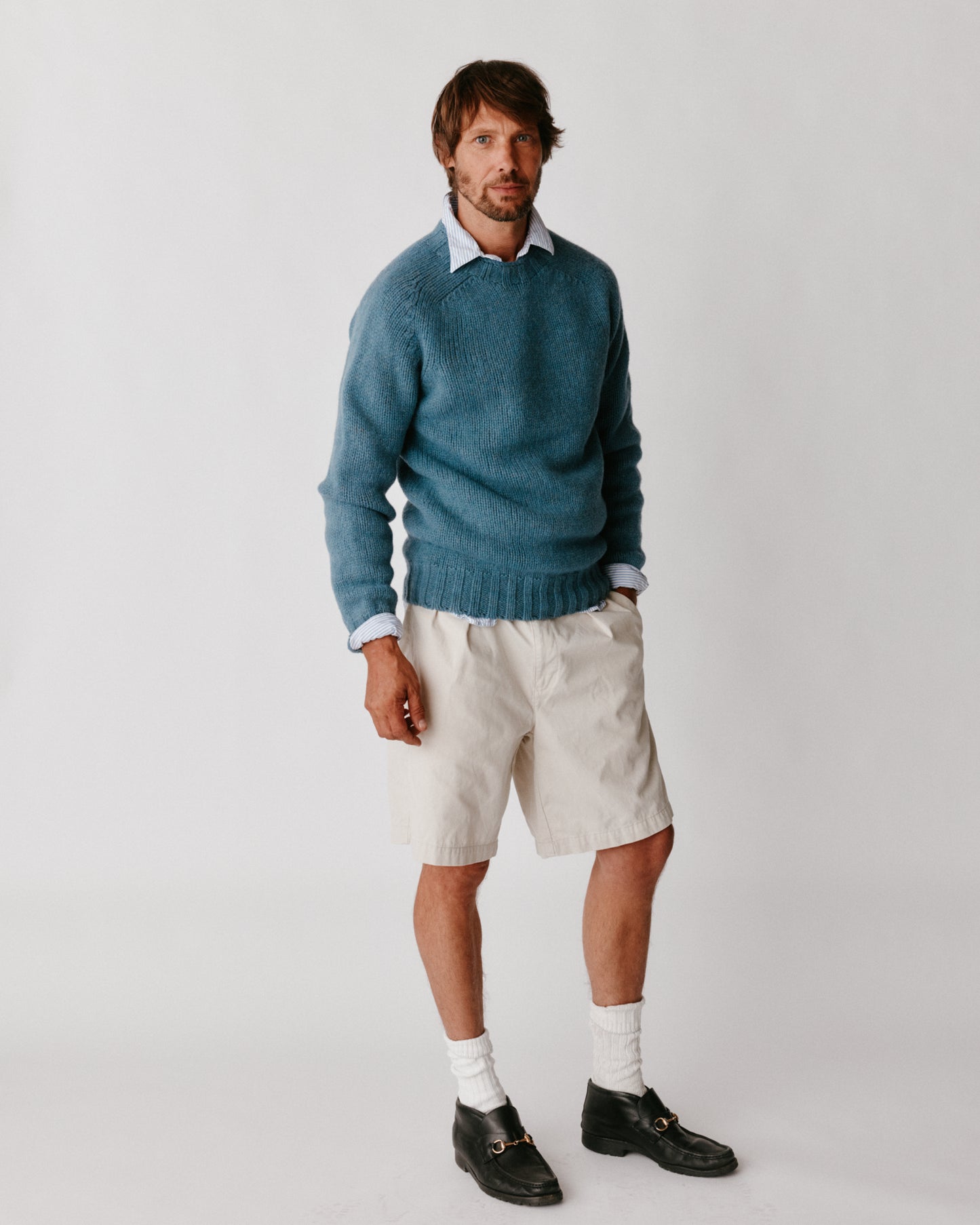 A model wearing a Bosie Blue Mogganer Explorer Extra Chunky Seamless Supersoft Shetland Sweater in colour Cirrus.
