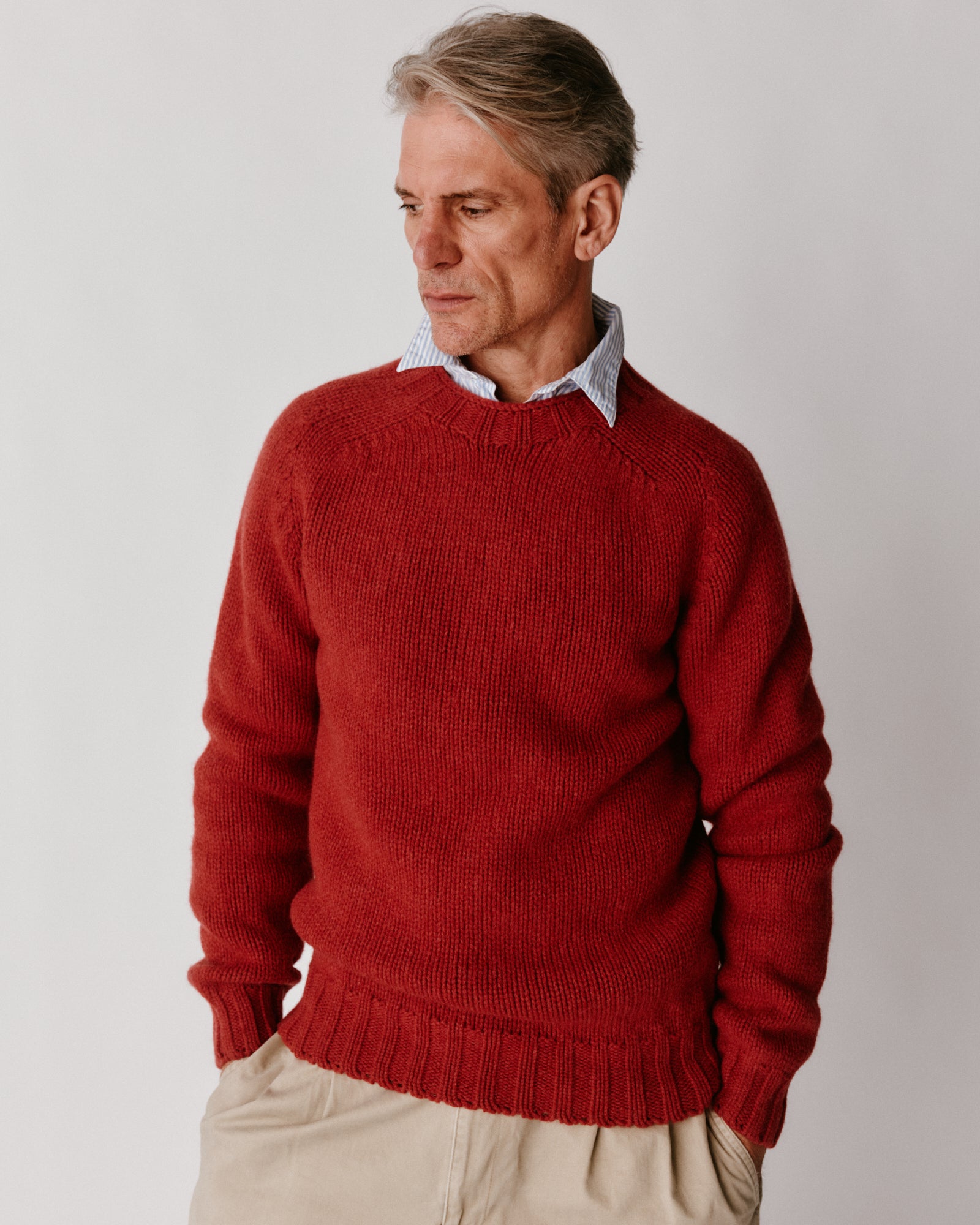 A model wearing a Bosie Blue Mogganer Explorer Extra Chunky Seamless Supersoft Shetland Sweater in colour Framboise.