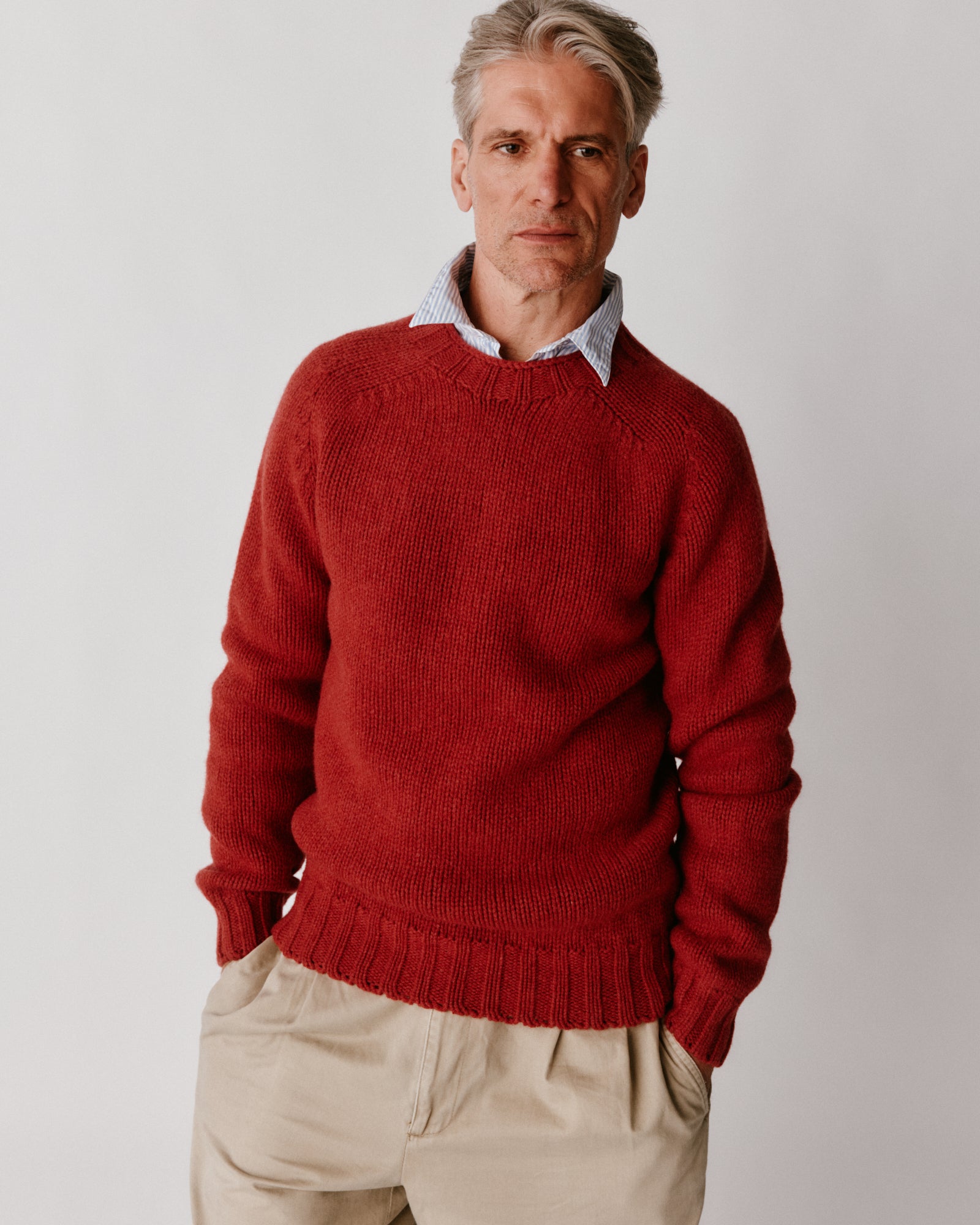 A model wearing a Bosie Blue Mogganer Explorer Extra Chunky Seamless Supersoft Shetland Sweater in colour Framboise.