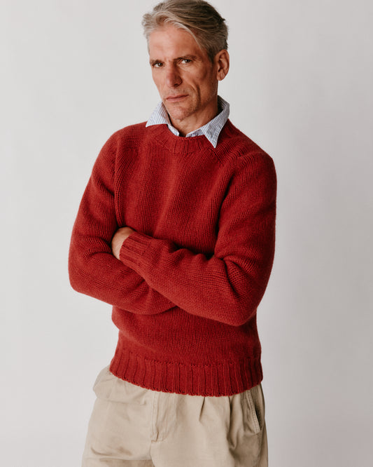 A model wearing a Bosie Blue Mogganer Explorer Extra Chunky Seamless Supersoft Shetland Sweater in colour Framboise.