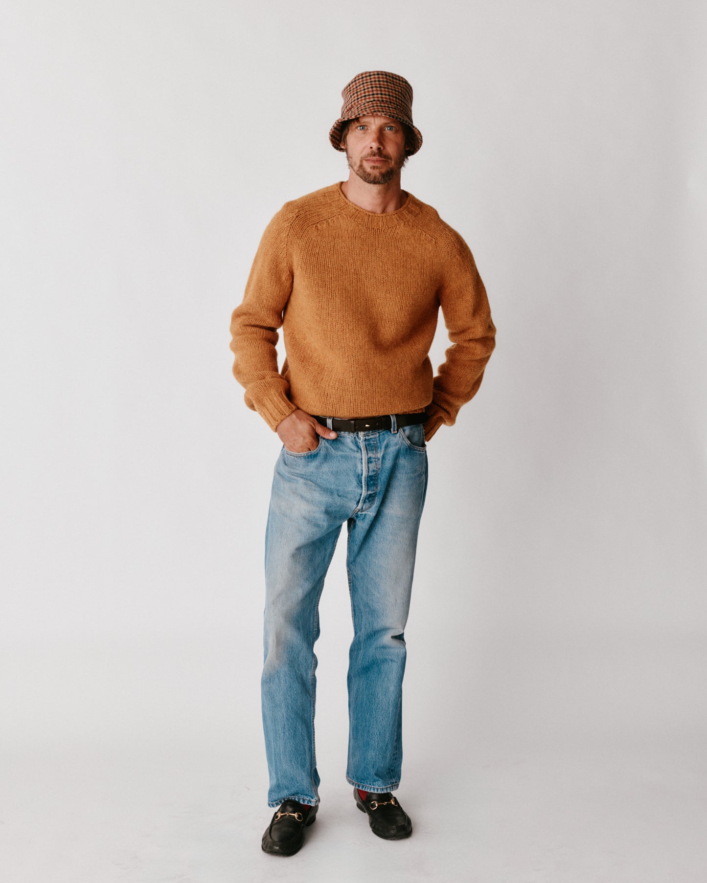 A model wearing a Bosie Blue Mogganer Explorer Extra Chunky Seamless Supersoft Shetland Sweater in colour Gold Dust / Cummin.