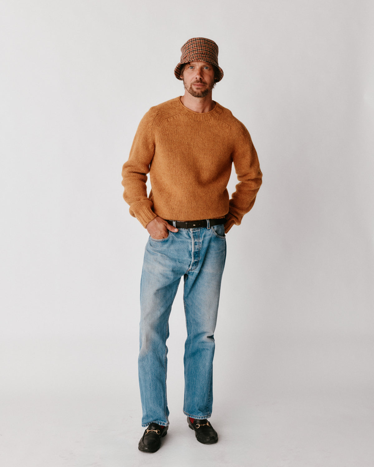 A model wearing a Bosie Blue Mogganer Explorer Extra Chunky Seamless Supersoft Shetland Sweater in colour Gold Dust / Cummin.