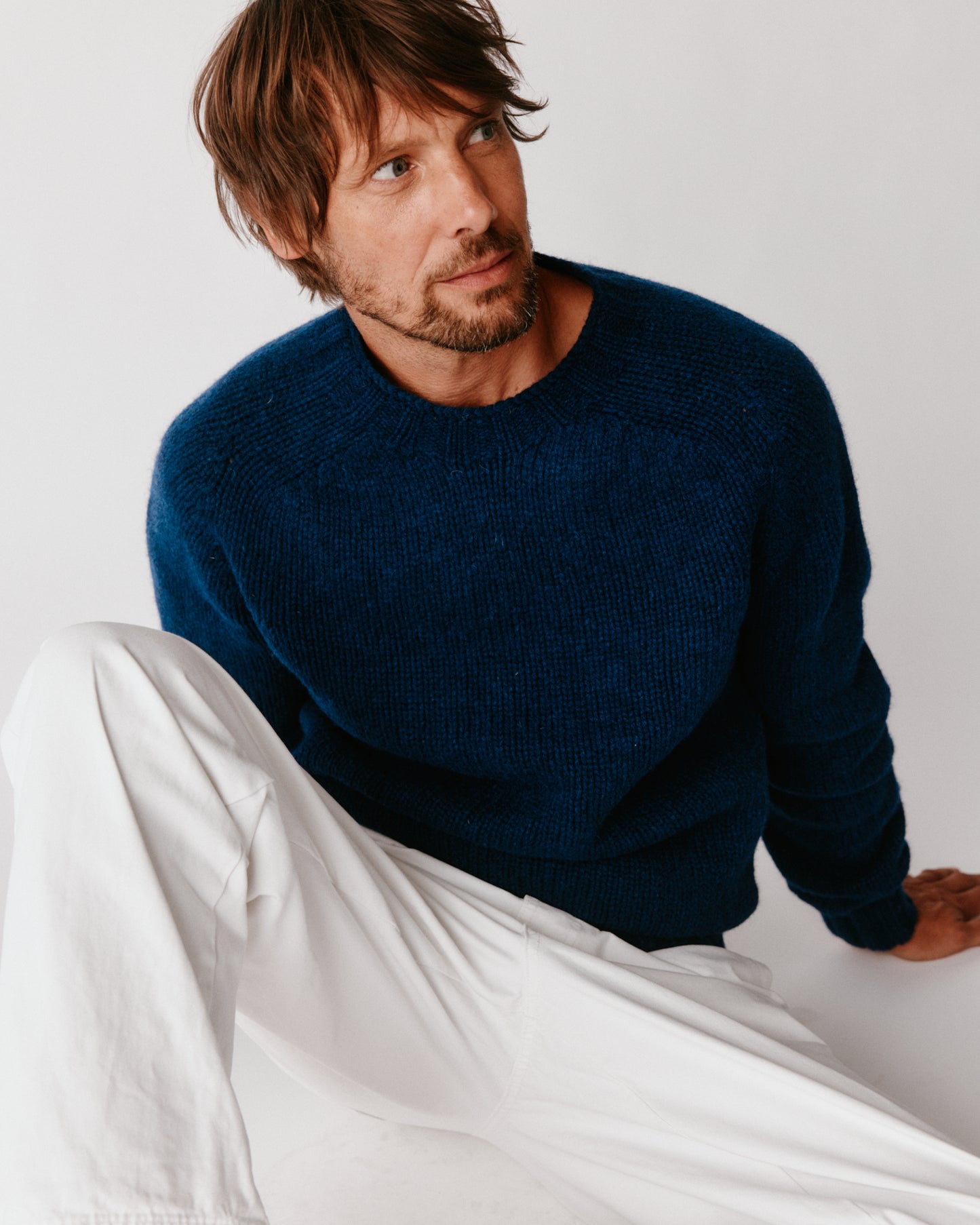 A model wearing a Bosie Blue Mogganer Explorer Extra Chunky Seamless Supersoft Shetland Sweater in colour Nightsky / Starnight Blue.
