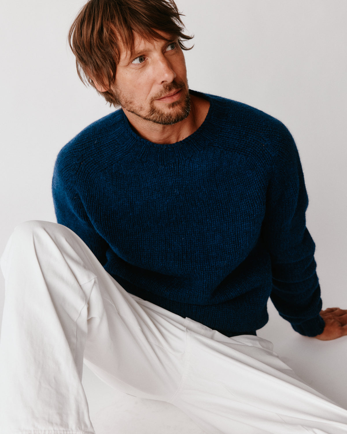 A model wearing a Bosie Blue Mogganer Explorer Extra Chunky Seamless Supersoft Shetland Sweater in colour Nightsky / Starnight Blue.