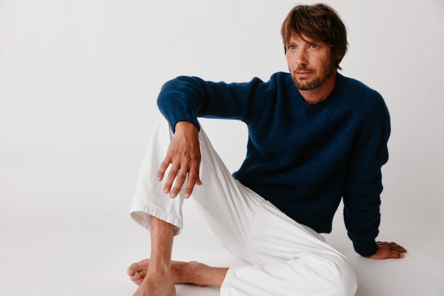 A model wearing a Bosie Blue Mogganer Explorer Extra Chunky Seamless Supersoft Shetland Sweater in colour Nightsky / Starnight Blue.