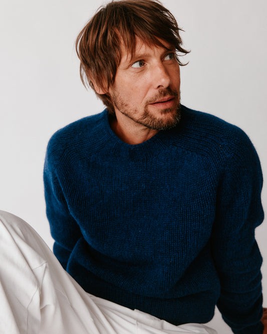 A model wearing a Bosie Blue Mogganer Explorer Extra Chunky Seamless Supersoft Shetland Sweater in colour Nightsky / Starnight Blue.