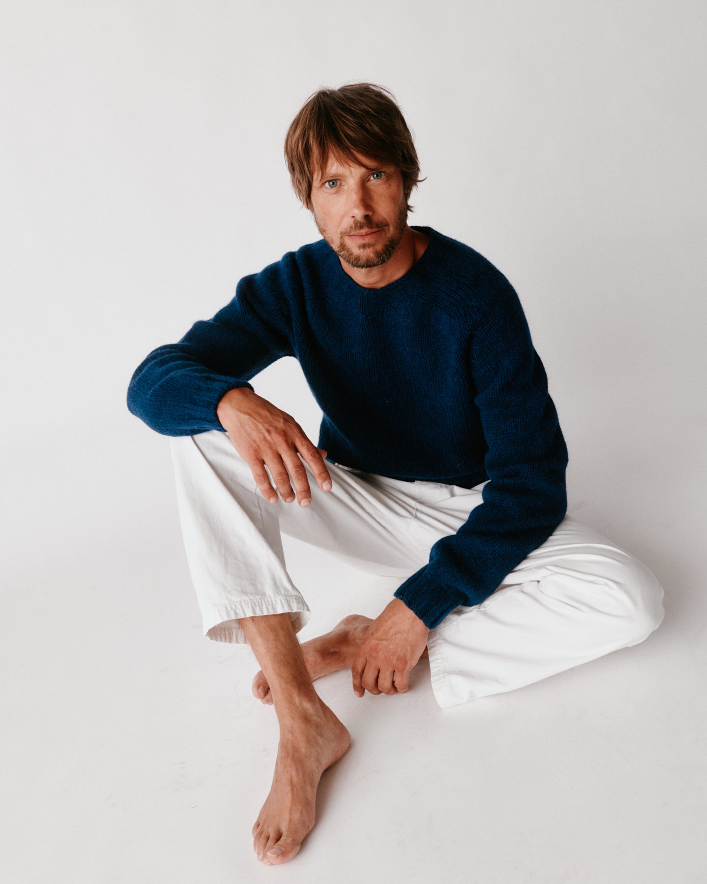 A model wearing a Bosie Blue Mogganer Explorer Extra Chunky Seamless Supersoft Shetland Sweater in colour Nightsky / Starnight Blue.