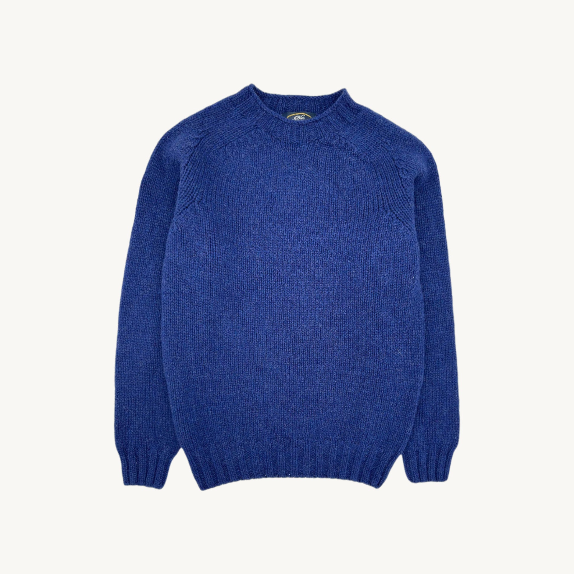 Flatbed photograph of a Bosie Knitwear Blue Mogganer Explorer Extra Chunky Seamless Supersoft Shetland Sweater in colour Oceana Blue.