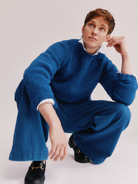 Model wearing a Bosie Knitwear Blue Mogganer Explorer Extra Chunky Seamless Supersoft Shetland Sweater in colour Oceana Blue.