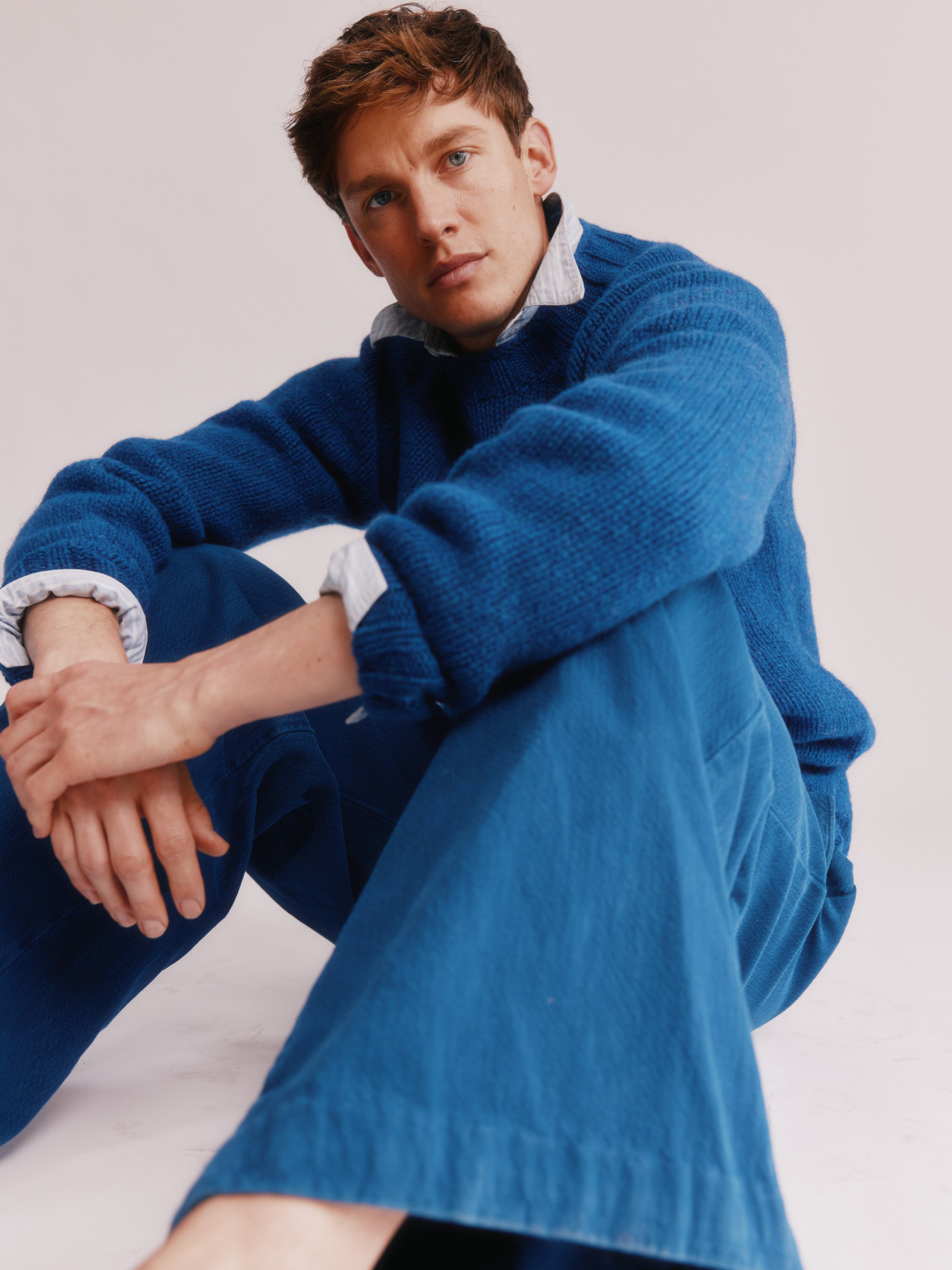 Model wearing a Bosie Knitwear Blue Mogganer Explorer Extra Chunky Seamless Supersoft Shetland Sweater in colour Oceana Blue.