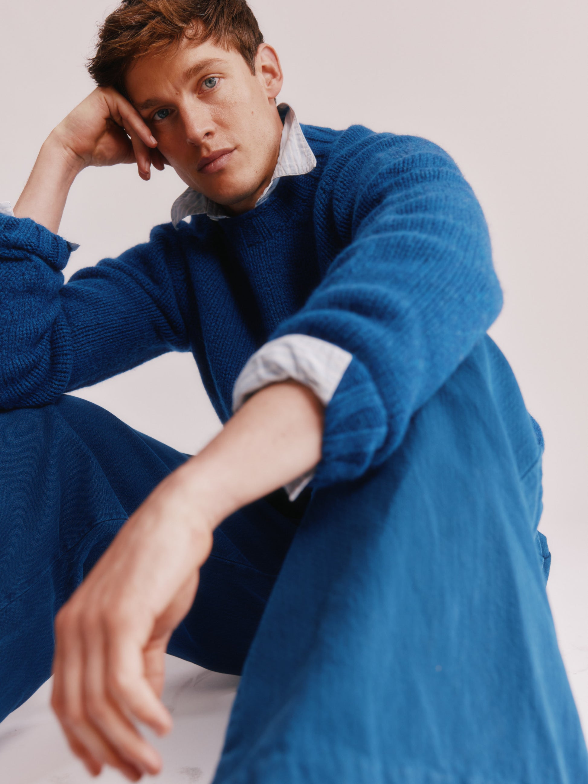 Model wearing a Bosie Knitwear Blue Mogganer Explorer Extra Chunky Seamless Supersoft Shetland Sweater in colour Oceana Blue.