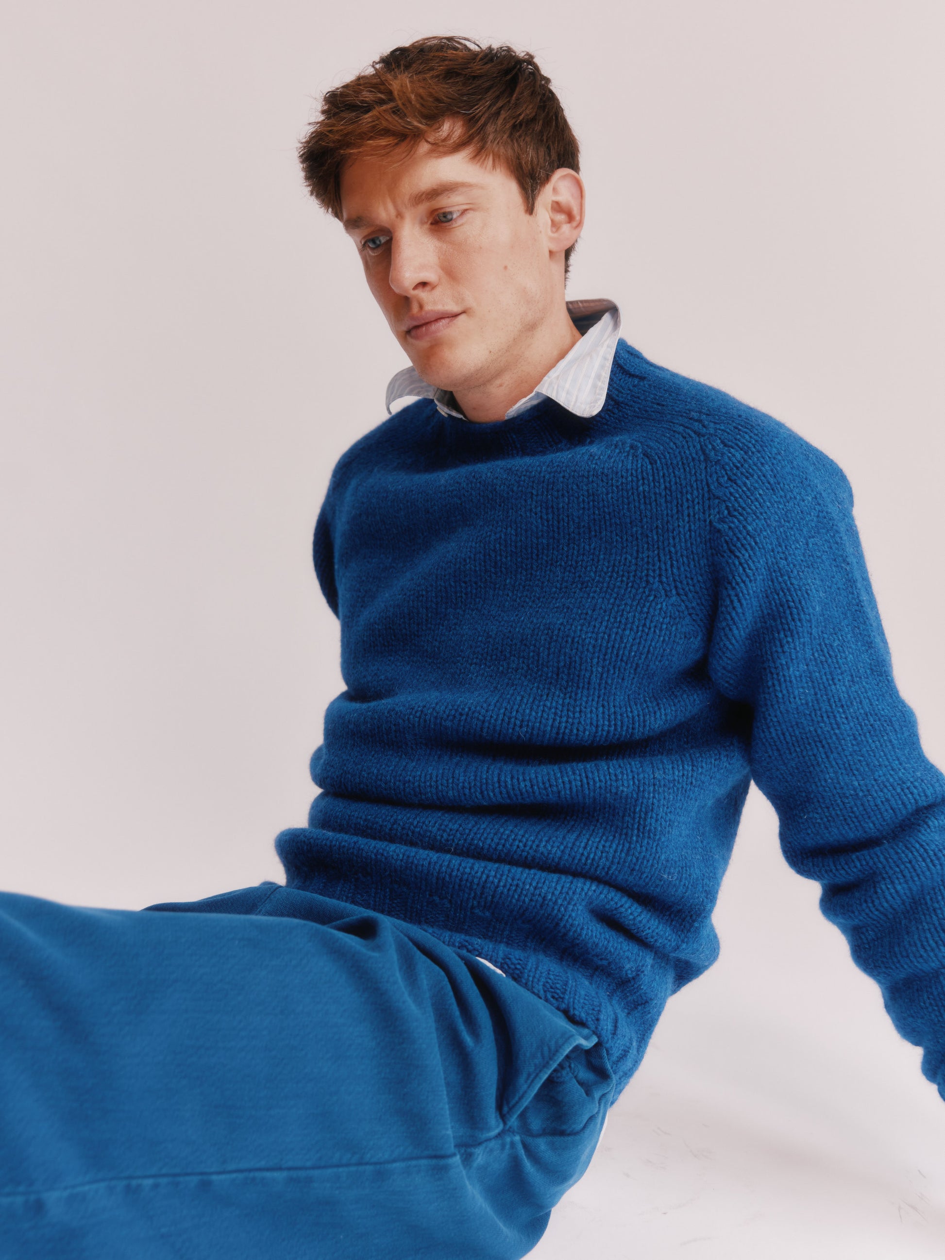 Model wearing a Bosie Knitwear Blue Mogganer Explorer Extra Chunky Seamless Supersoft Shetland Sweater in colour Oceana Blue.