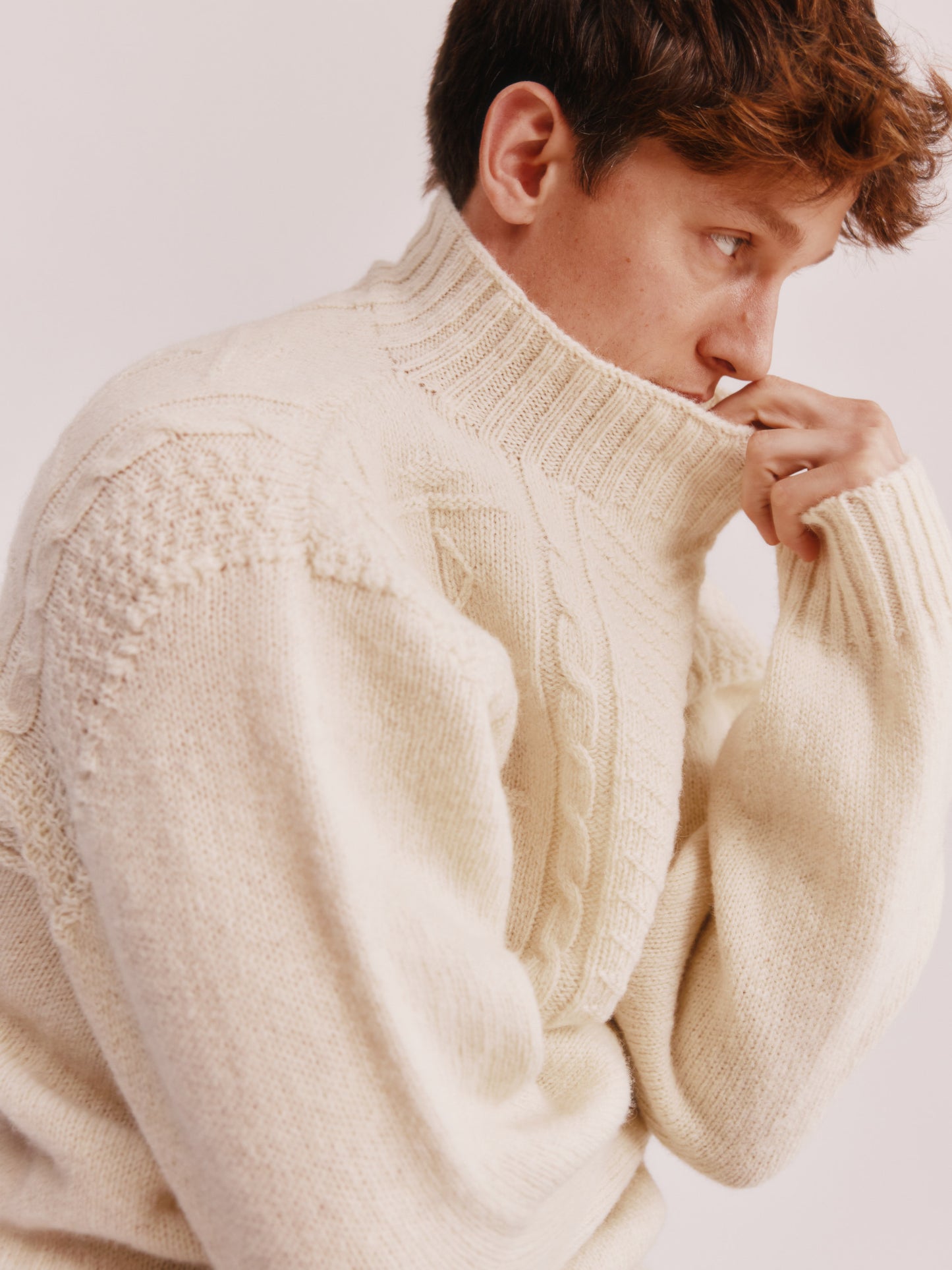 Model wearing a Bosie Knitwear Blue Mogganer Ganjey Heritage Heather Knoll Crew Neck Sweater in colour Ecru White.