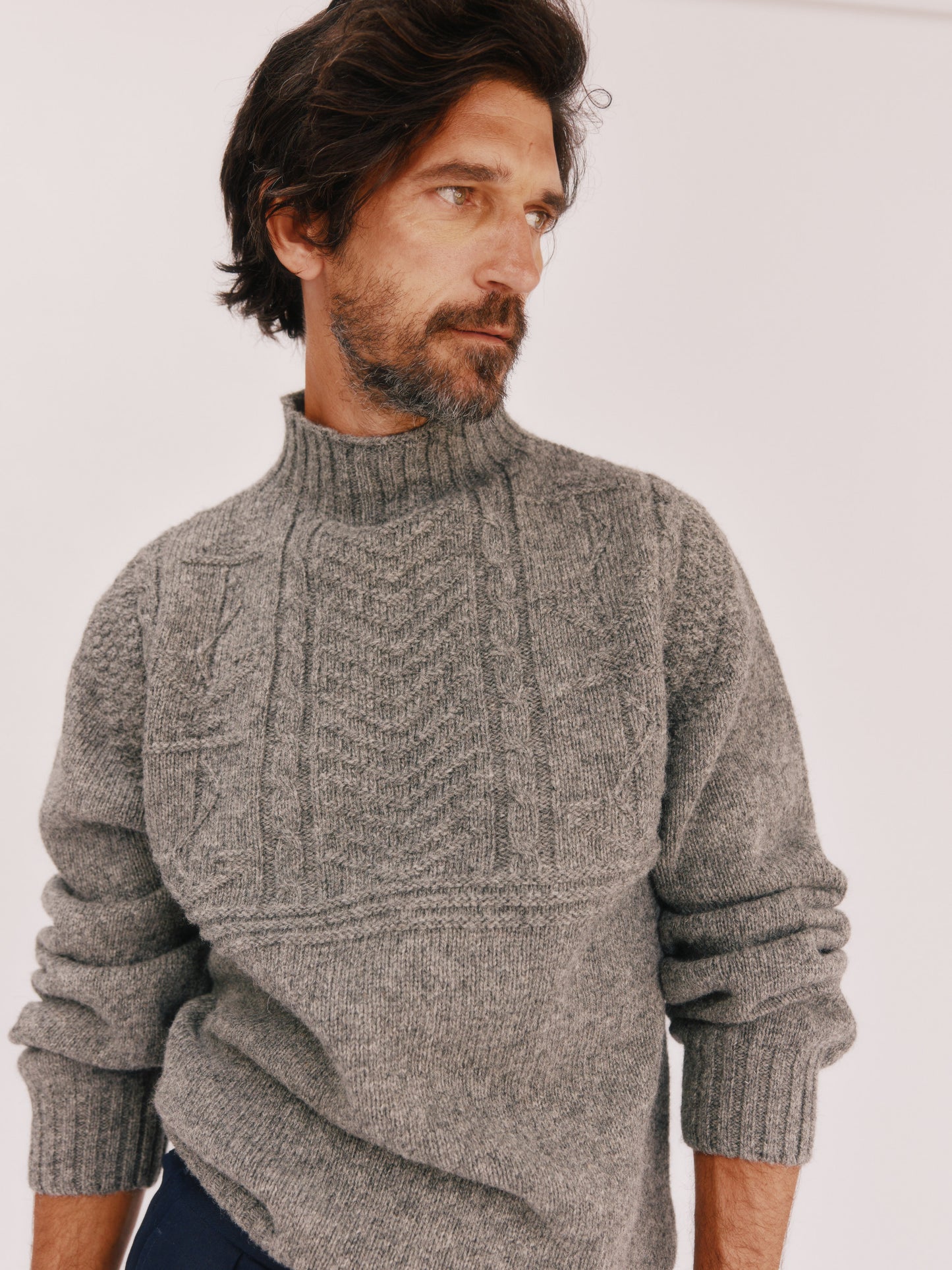 Model wearing a Bosie Knitwear Blue Mogganer Ganjey Heritage Heather Knoll Crew Neck Sweater in colour Med Grey.