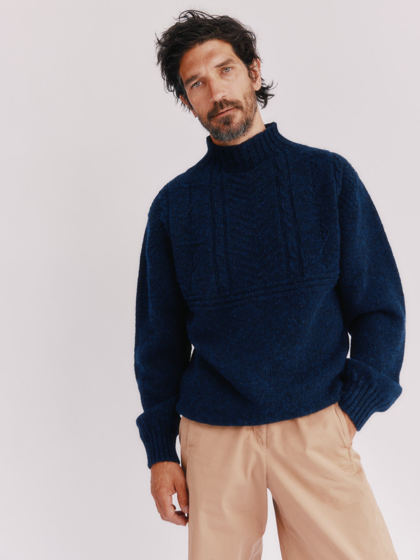 Model wearing a Bosie Knitwear Blue Mogganer Ganjey Heritage Heather Knoll Crew Neck Sweater in colour Navy. 