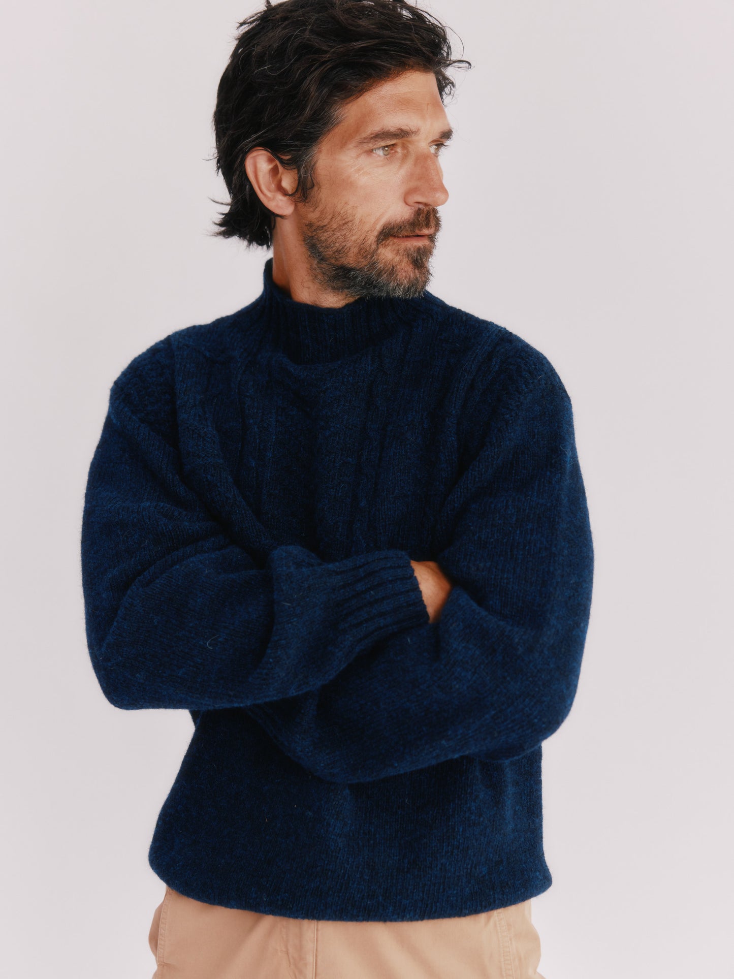 Model wearing a Bosie Knitwear Blue Mogganer Ganjey Heritage Heather Knoll Crew Neck Sweater in colour Navy. 