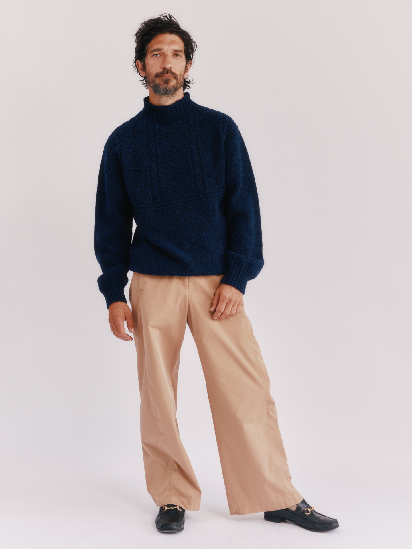 Model wearing a Bosie Knitwear Blue Mogganer Ganjey Heritage Heather Knoll Crew Neck Sweater in colour Navy. 