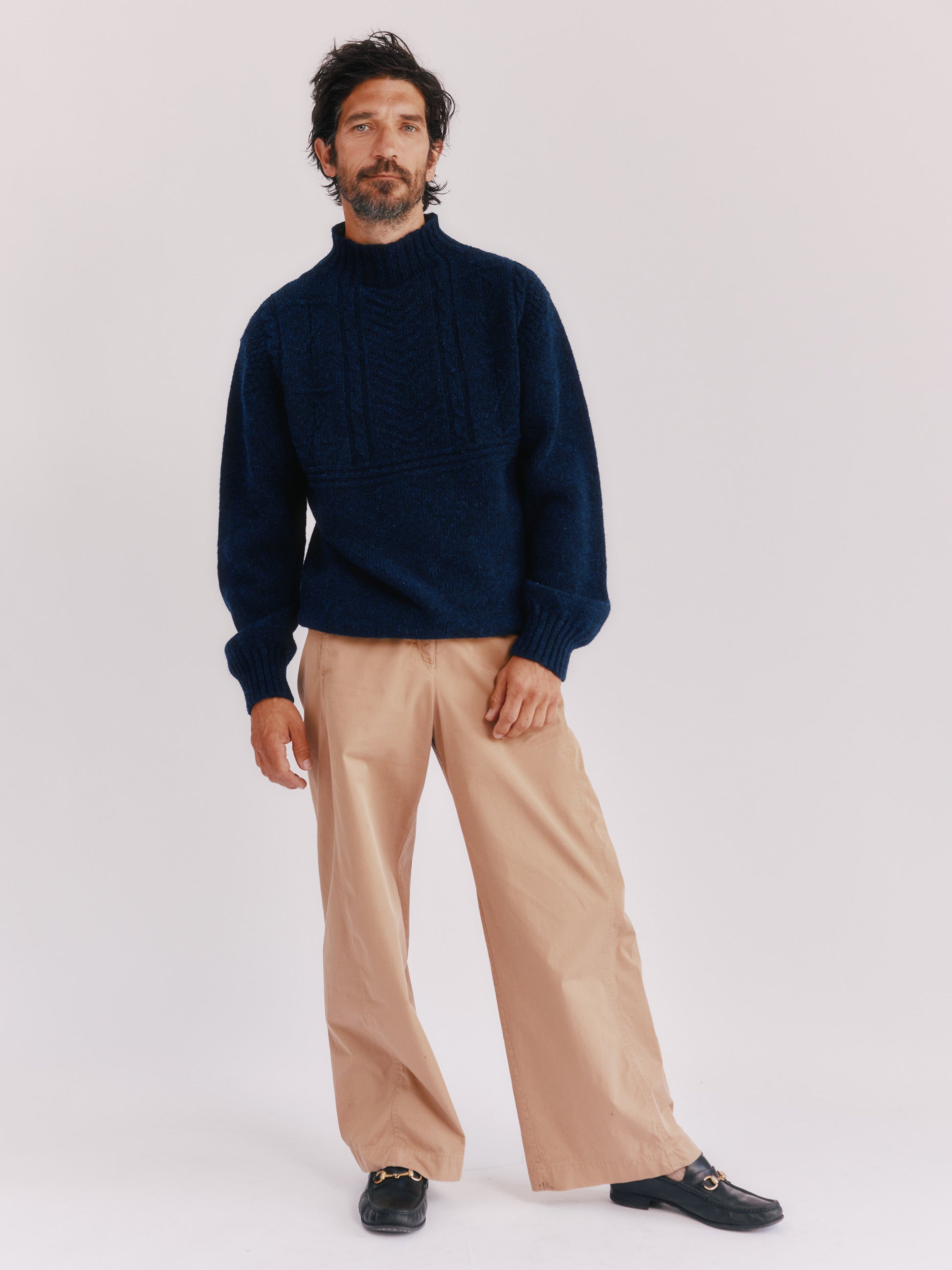 Model wearing a Bosie Knitwear Blue Mogganer Ganjey Heritage Heather Knoll Crew Neck Sweater in colour Navy. 