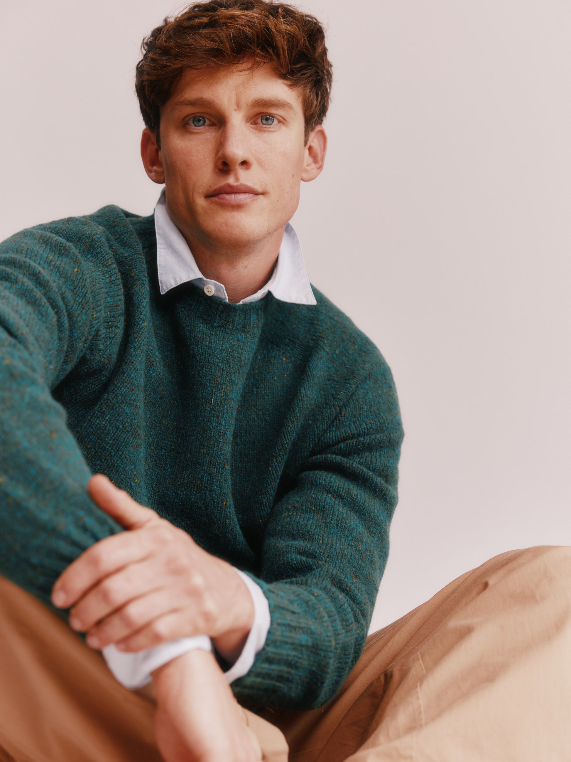 Model wearing a Bosie Knitwear Blue Mogganer Helmsman Glenugie Nep Sweater in colour Canna Green.