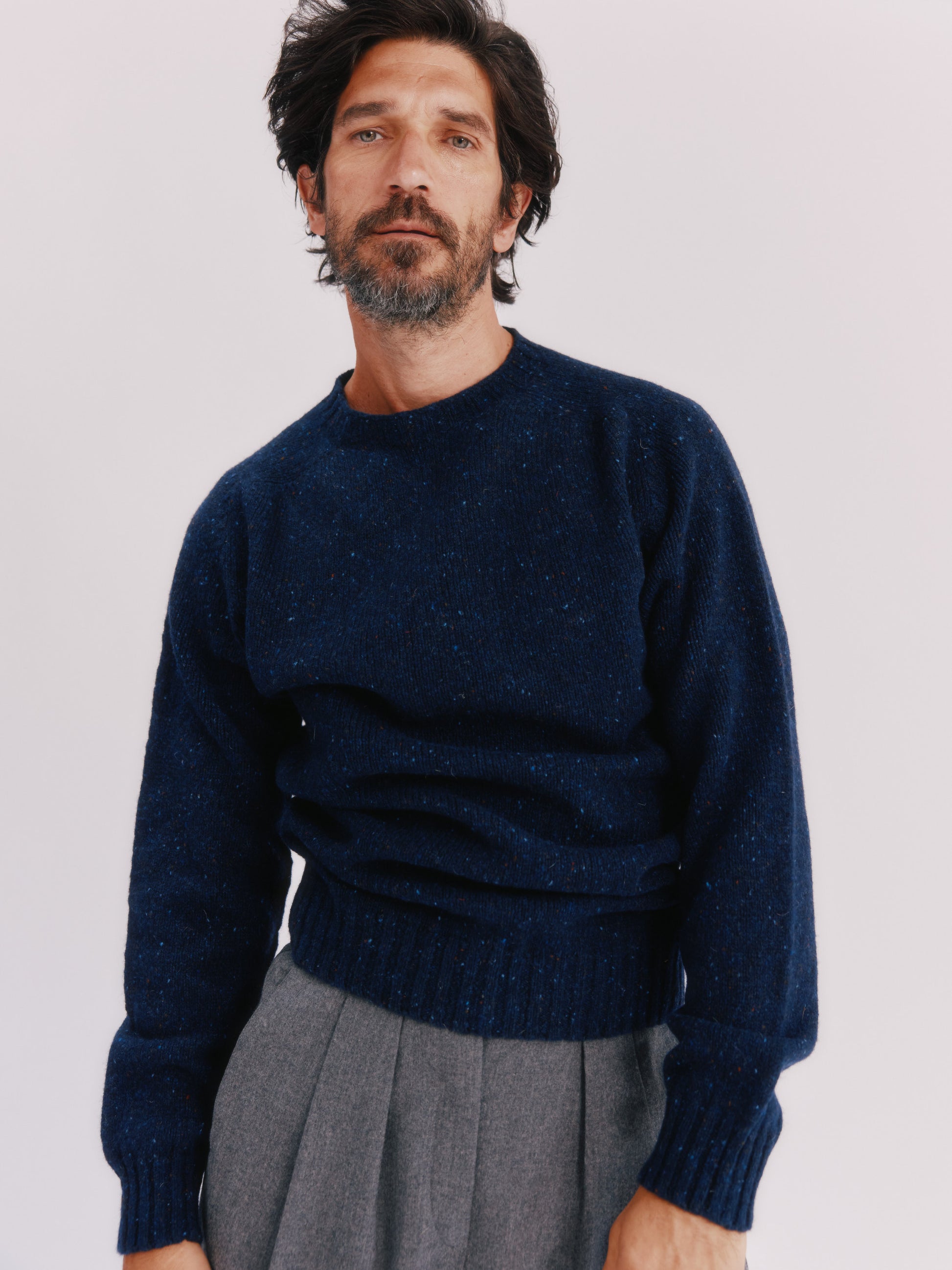 Model wearing a Bosie Knitwear Blue Mogganer Helmsman Glenugie Nep Sweater in colour Jura Navy.