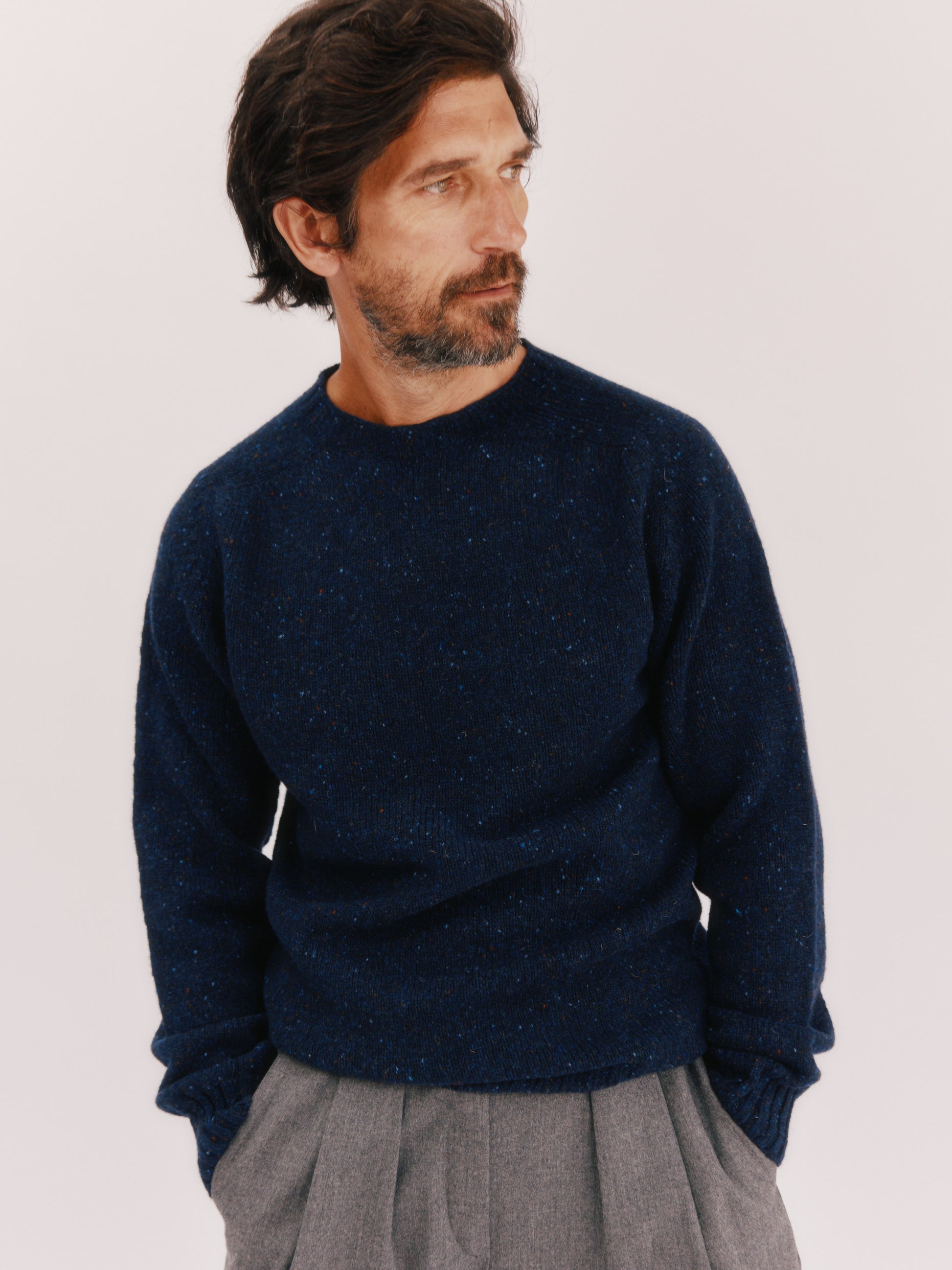 Model wearing a Bosie Knitwear Blue Mogganer Helmsman Glenugie Nep Sweater in colour Jura Navy.