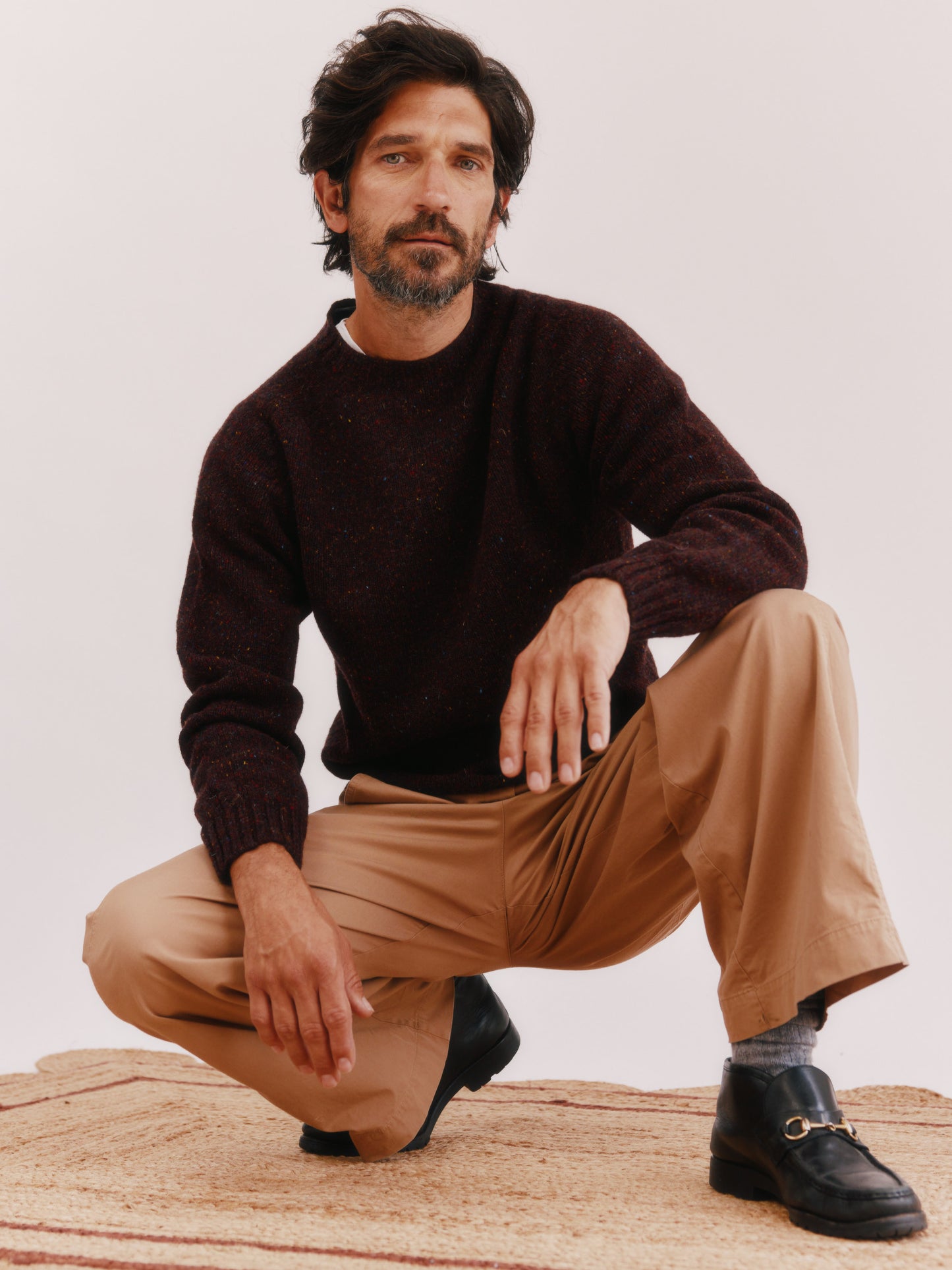 Model wearing a Bosie Knitwear Blue Mogganer Helmsman Glenugie Nep Sweater in colour Lewis Dark Aubergine.