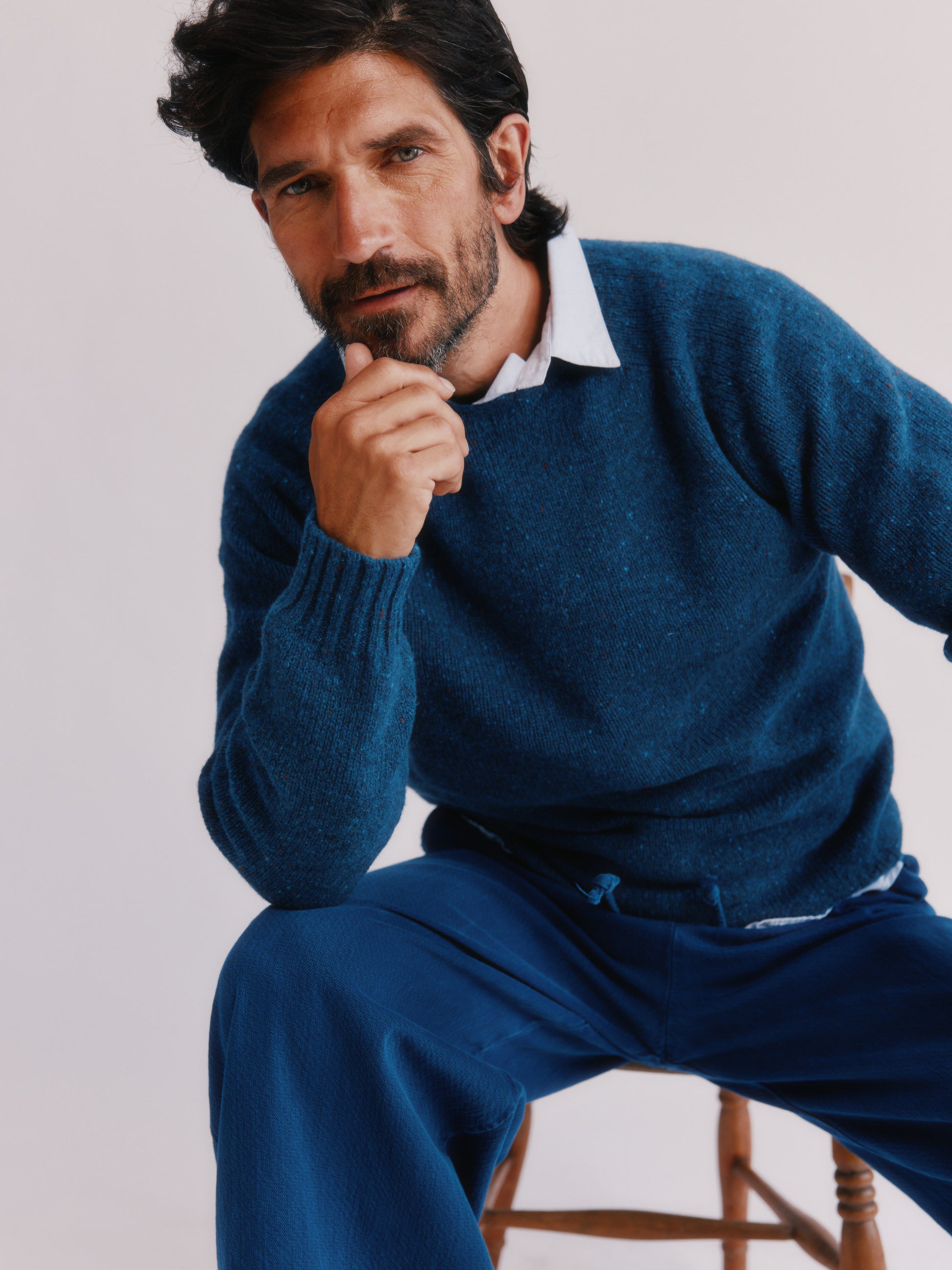 Flatbed photograph of a Bosie Knitwear Blue Mogganer Helmsman Glenugie Nep Sweater in colour Soay Blue.