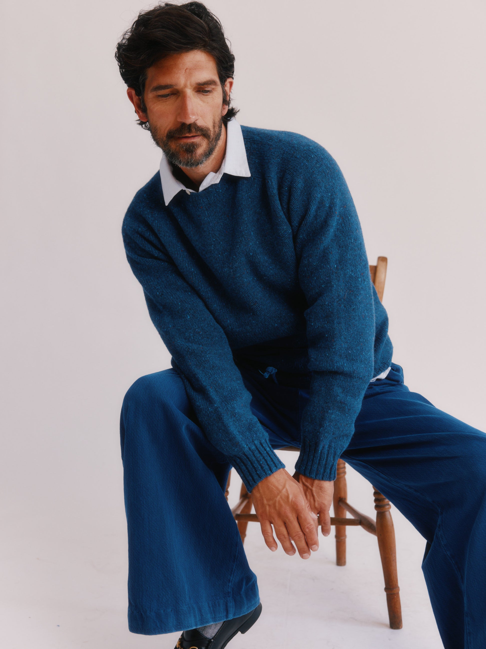 Flatbed photograph of a Bosie Knitwear Blue Mogganer Helmsman Glenugie Nep Sweater in colour Soay Blue.