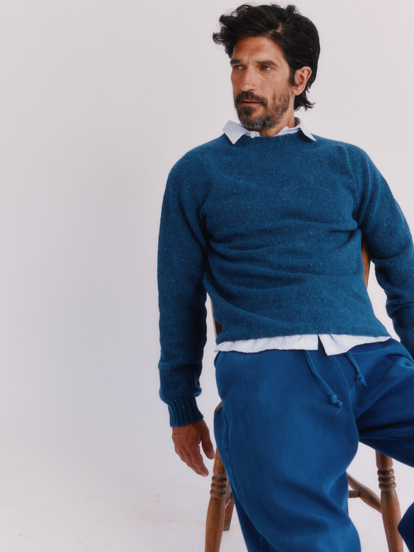 Flatbed photograph of a Bosie Knitwear Blue Mogganer Helmsman Glenugie Nep Sweater in colour Soay Blue.