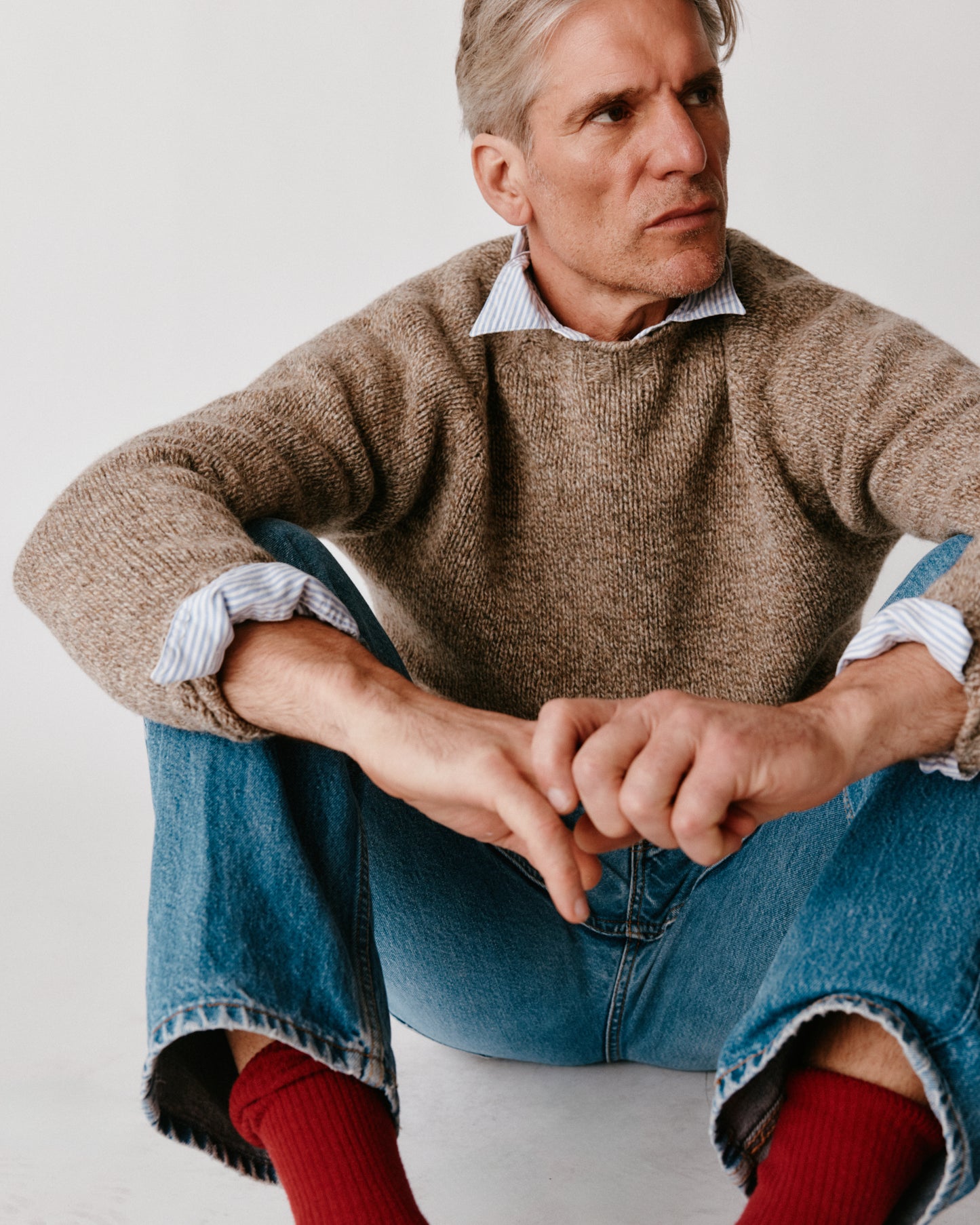 A model wearing a Bosie Blue Mogganer North Sea Chunky Seamless Supersoft Shetland Sweater in colour  Pebble / Mushroom.