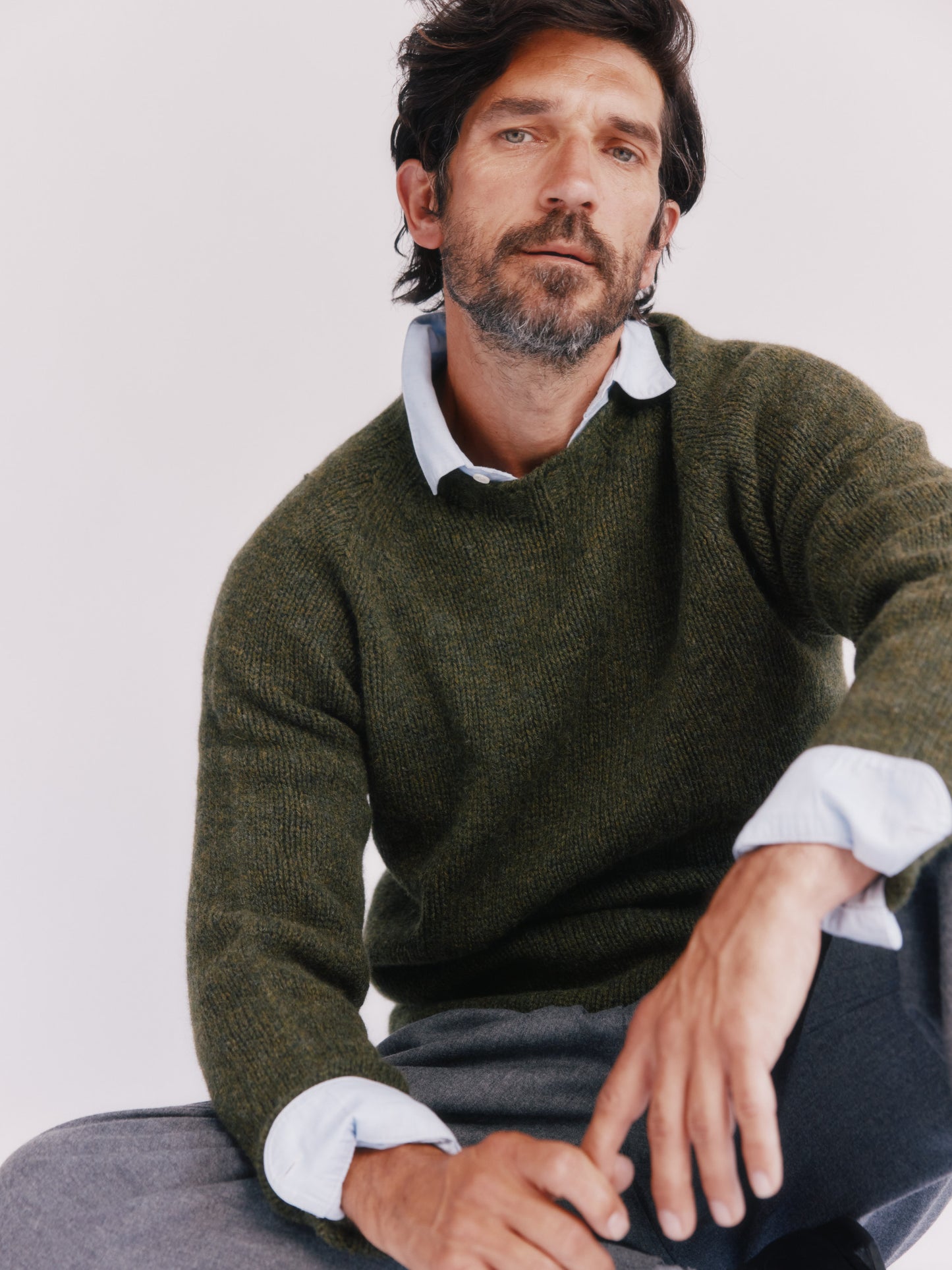 Model wearing a Bosie Knitwear Blue Mogganer North Sea Chunky Seamless Supersoft Shetland Sweater in colour Pineshadow Green.