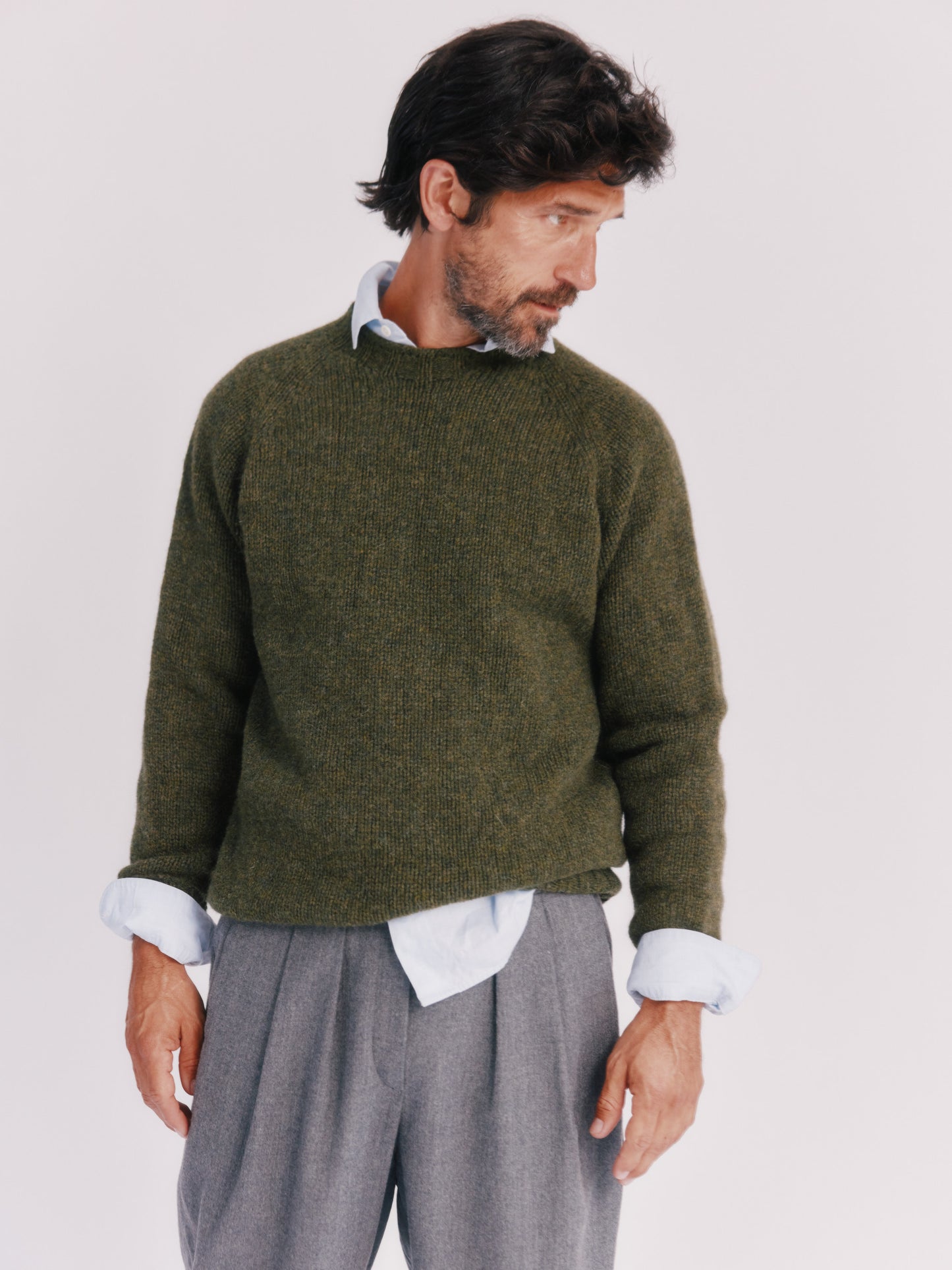 Model wearing a Bosie Knitwear Blue Mogganer North Sea Chunky Seamless Supersoft Shetland Sweater in colour Pineshadow Green.