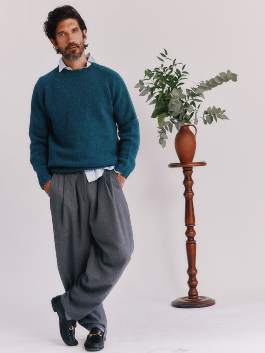 Model wearing a Bosie Knitwear Blue Mogganer North Sea Chunky Seamless Supersoft Shetland Sweater in colour Storm Dark Teal.