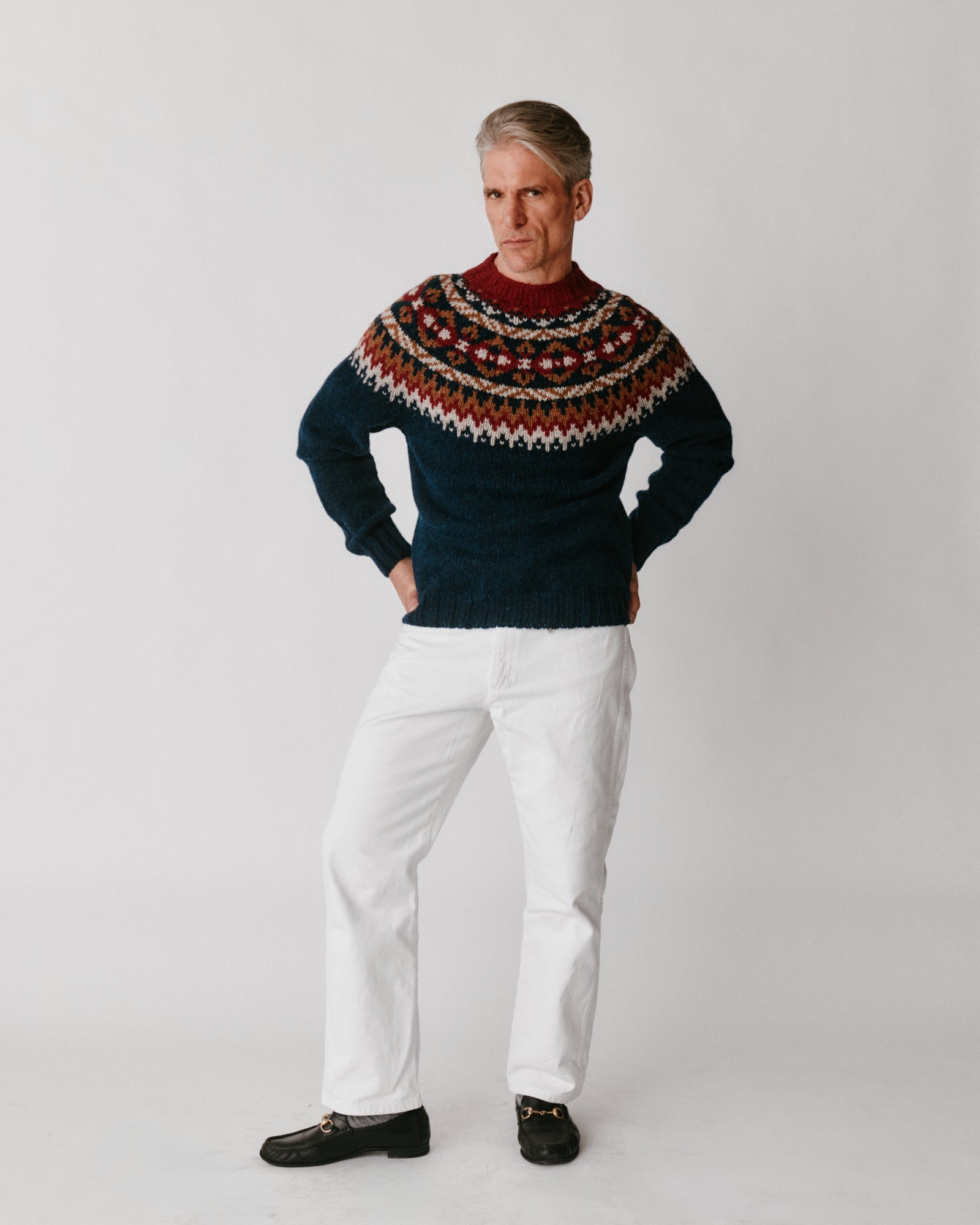 A model wearing a Bosie Blue Mogganer Northeaster Fairisle Yoke Chunky Ecology British Wool in colour Yew Navy.