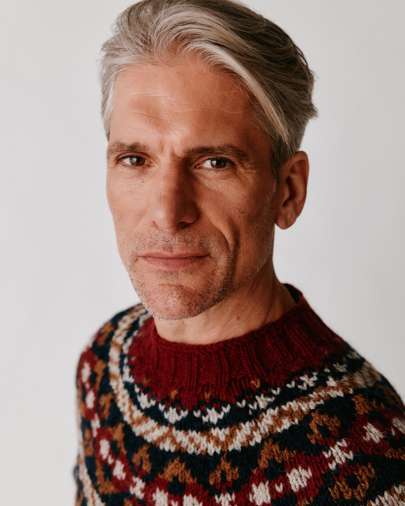 A model wearing a Bosie Blue Mogganer Northeaster Fairisle Yoke Chunky Ecology British Wool in colour Yew Navy.