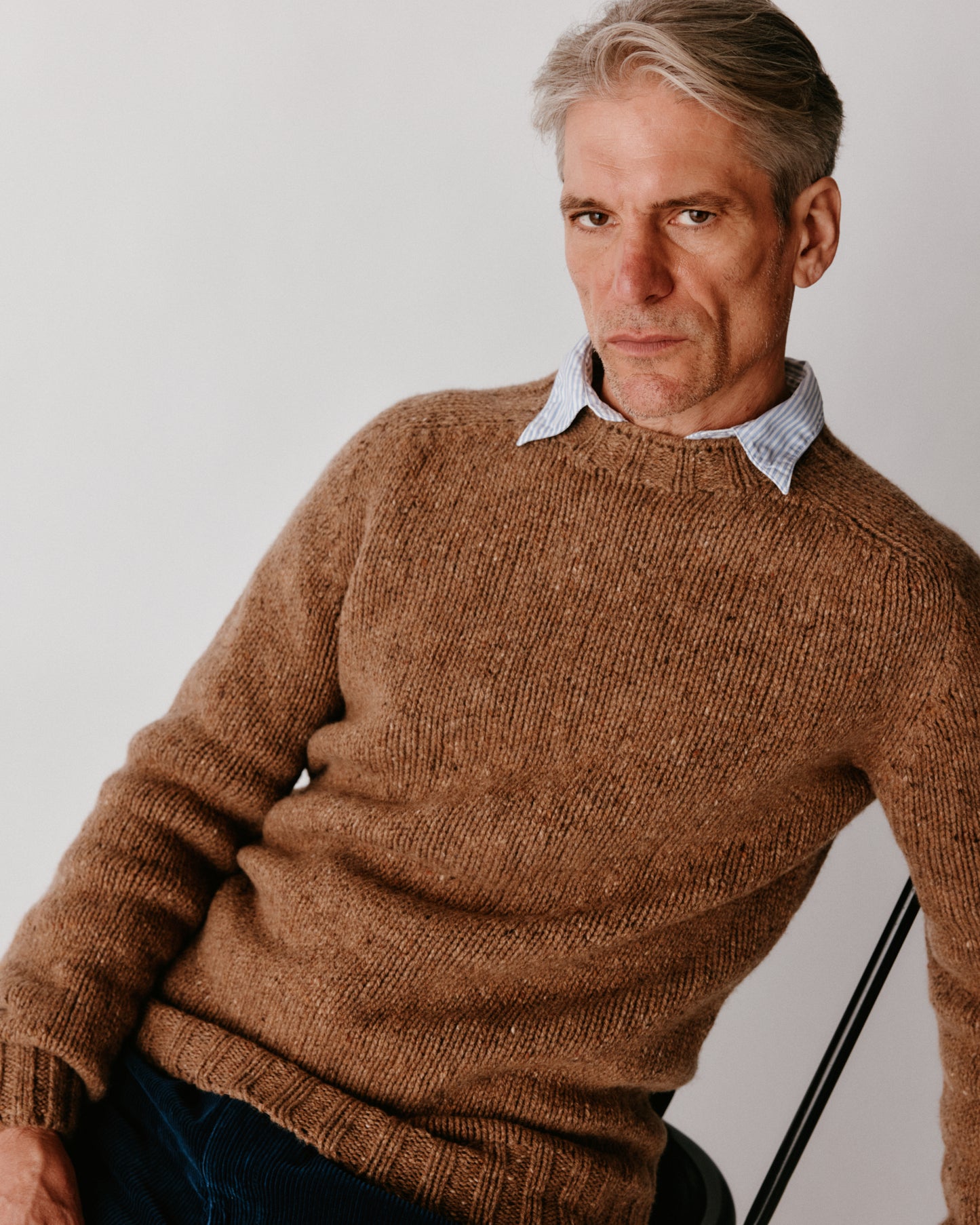 A model wearing a Bosie Blue Mogganer Trawlerman Chunky Glenugie Nep Sweater in colour Knoydart.