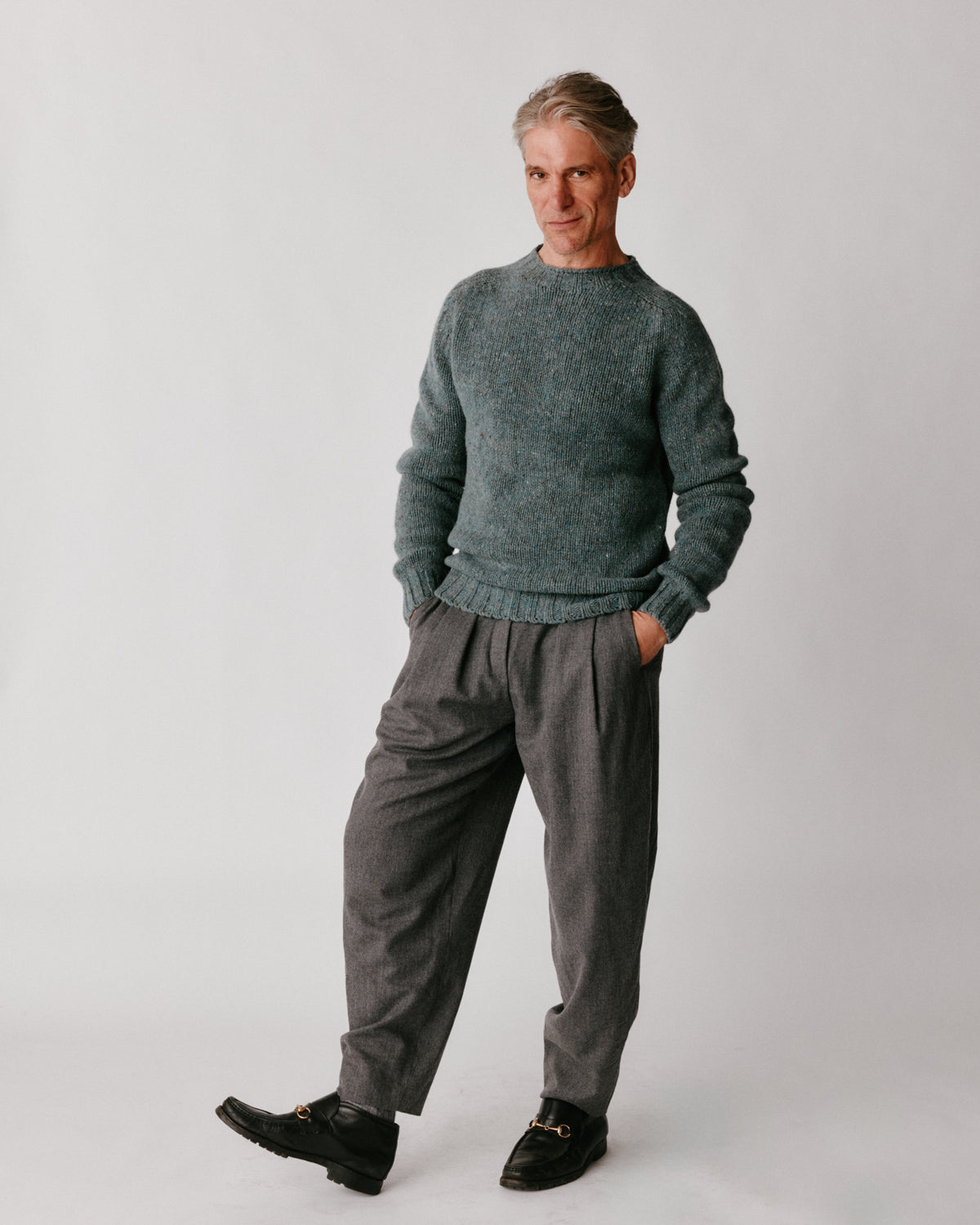 A model wearing a Bosie Blue Mogganer Trawlerman Chunky Glenugie Nep Sweater in colour Lomond.