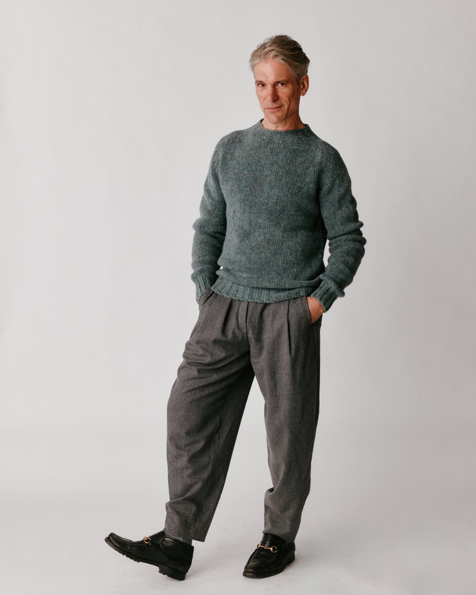 A model wearing a Bosie Blue Mogganer Trawlerman Chunky Glenugie Nep Sweater in colour Lomond.