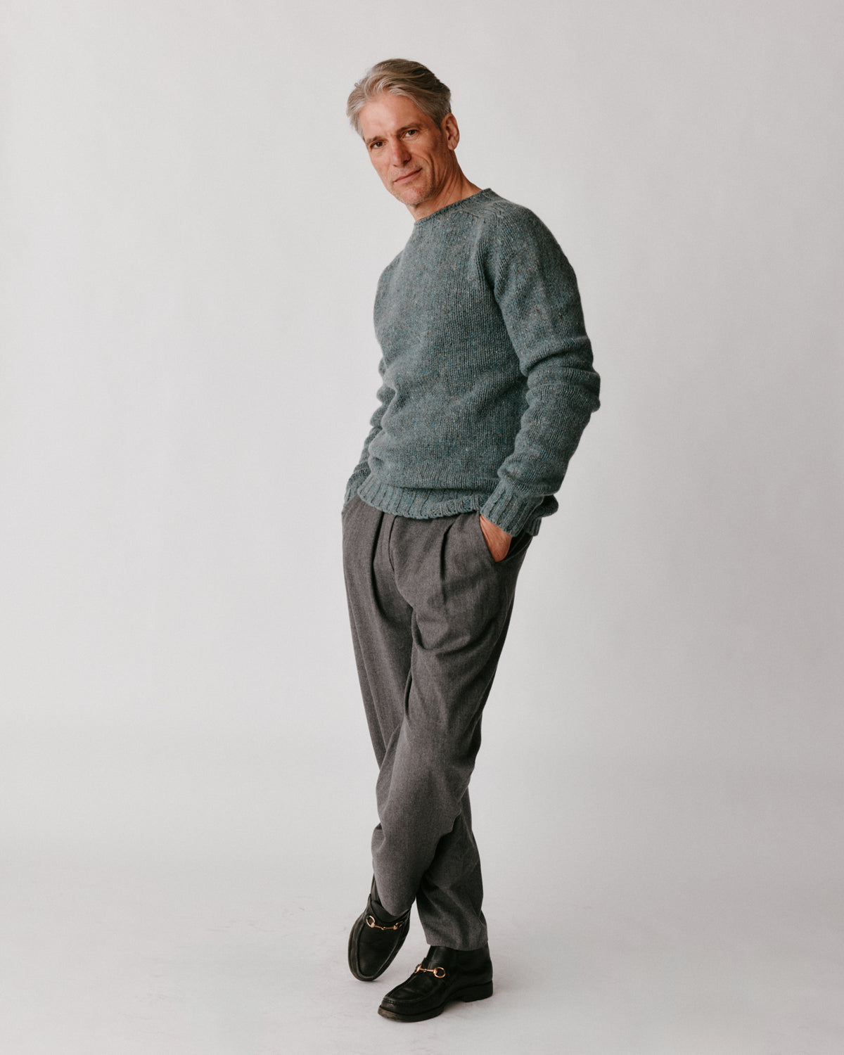A model wearing a Bosie Blue Mogganer Trawlerman Chunky Glenugie Nep Sweater in colour Lomond.