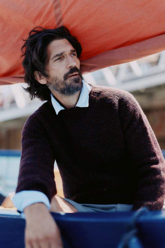 Model wearing a Bosie Knitwear Blue Mogganer Trawlerman Chunky Glenugie Nep Sweater in colour Lewis Dark Aubergine.