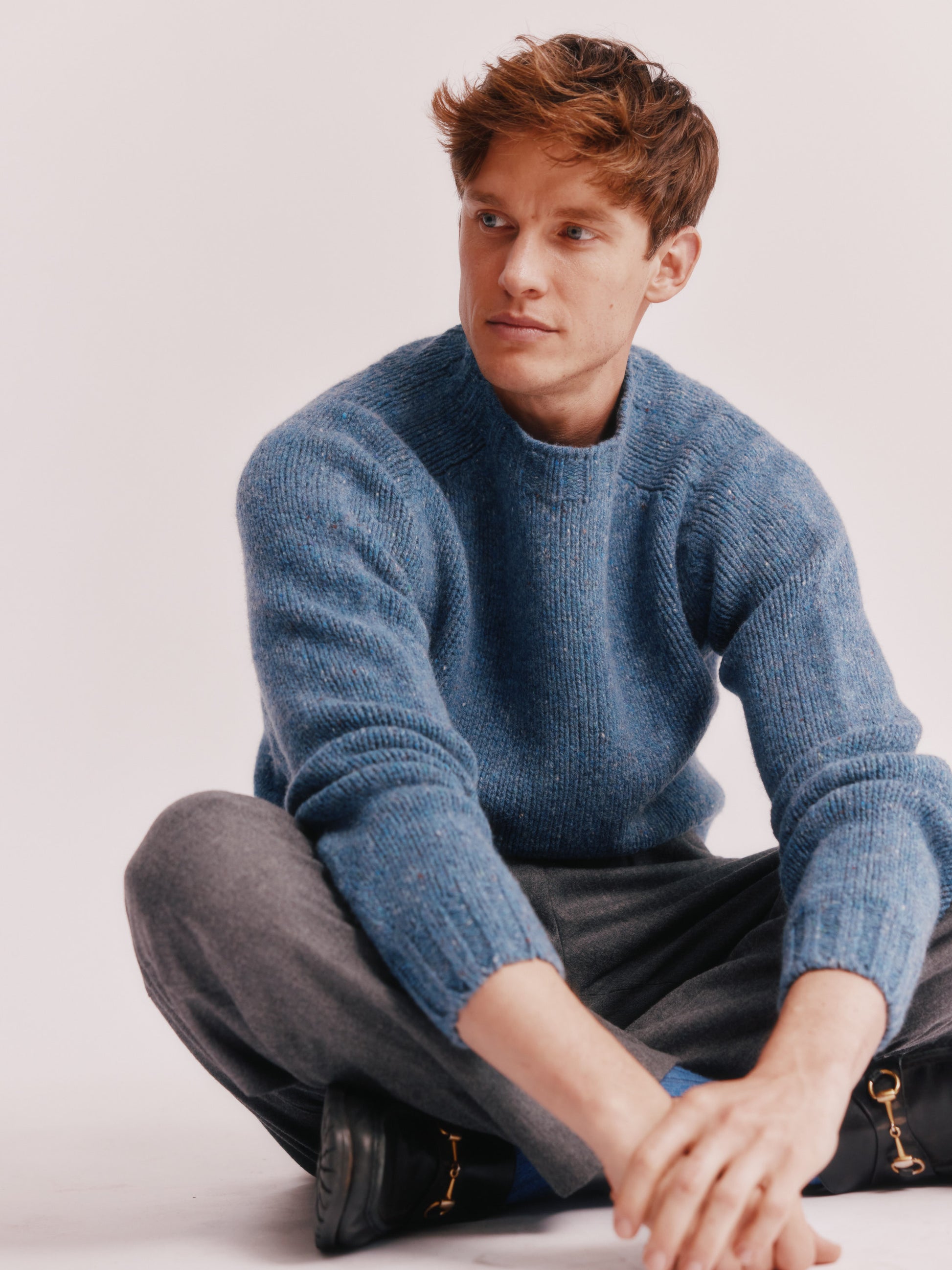 Model wearing a Bosie Knitwear Blue Mogganer Trawlerman Chunky Glenugie Nep Sweater in colour Ossian Blue.